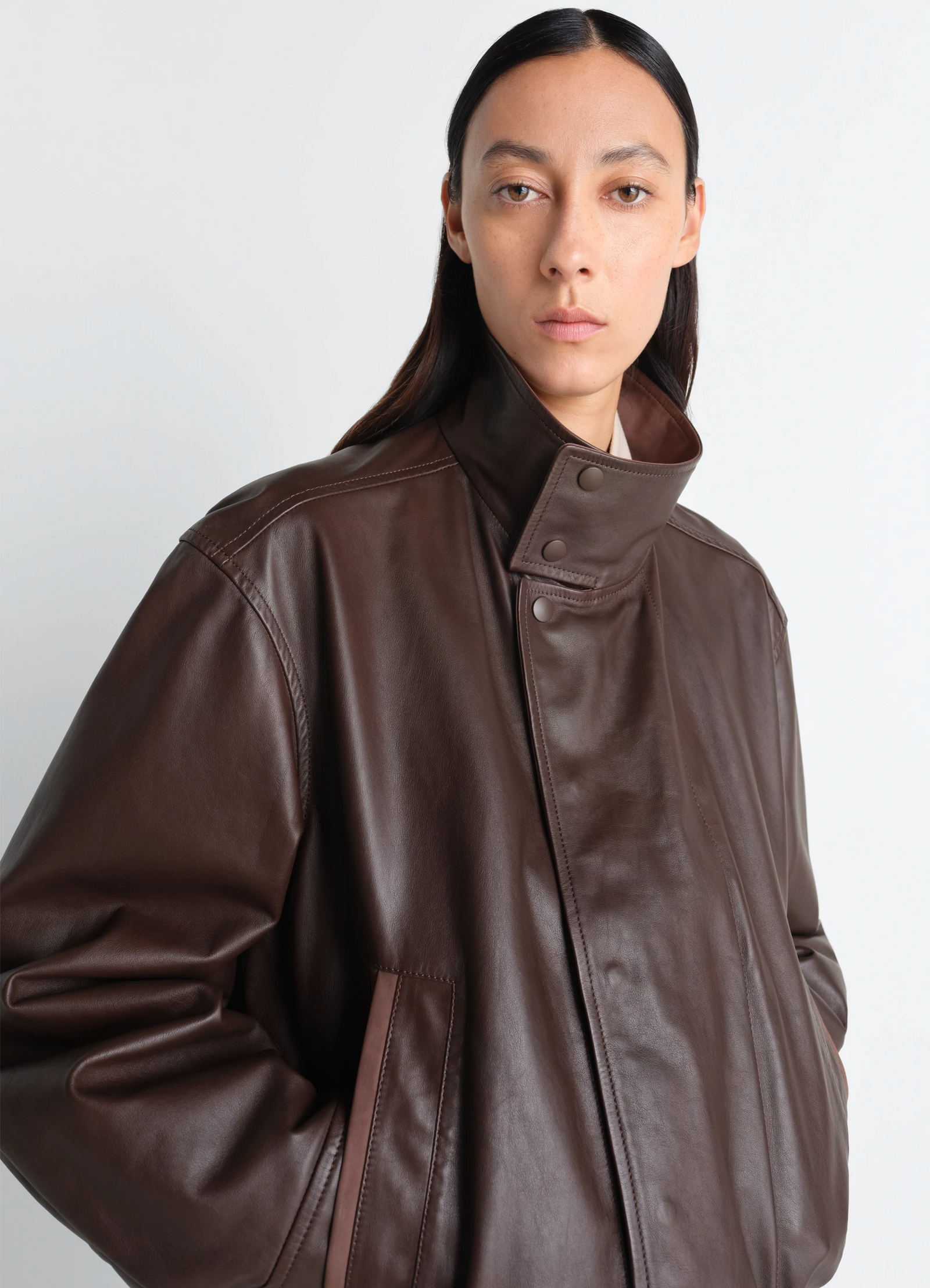 Lemaire soft leather blouson in paper leather, model shot, close-up upper body view high collar with snap buttons