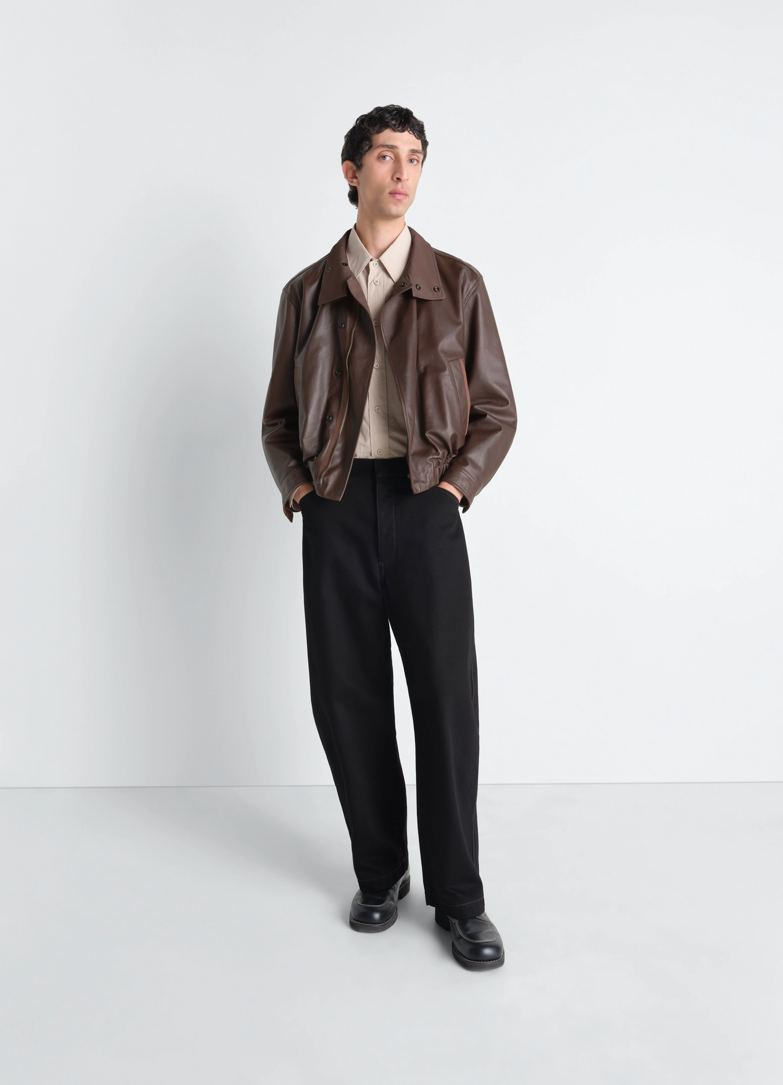 Lemaire soft leather blouson in paper leather, model shot, full body side view straight cut, hands in pockets