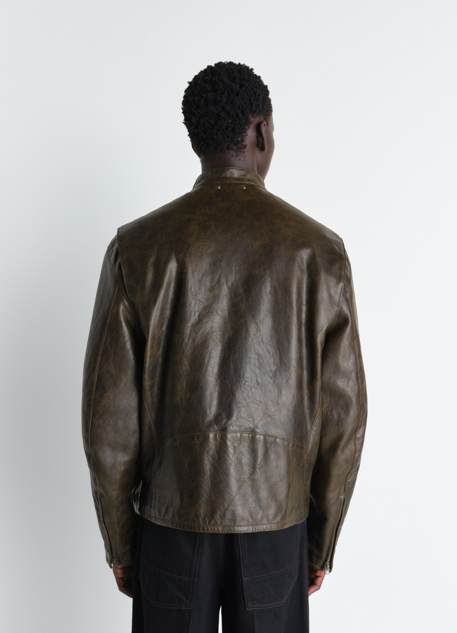 Boxy biker jacket in waxy cow leather, model shot, back view draped loose fit