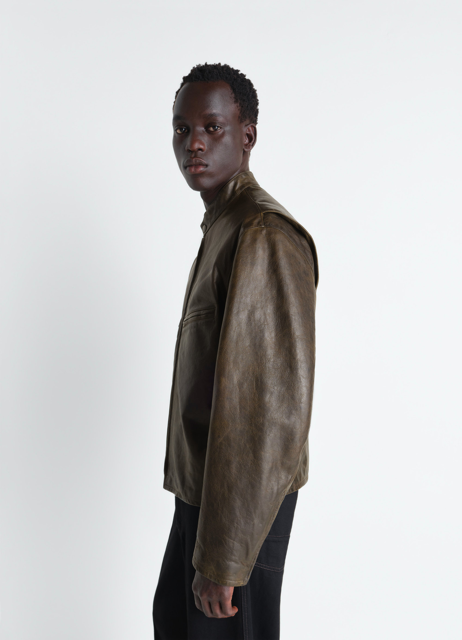 Boxy biker jacket in waxy cow leather, model shot, side view shoulder detail visible