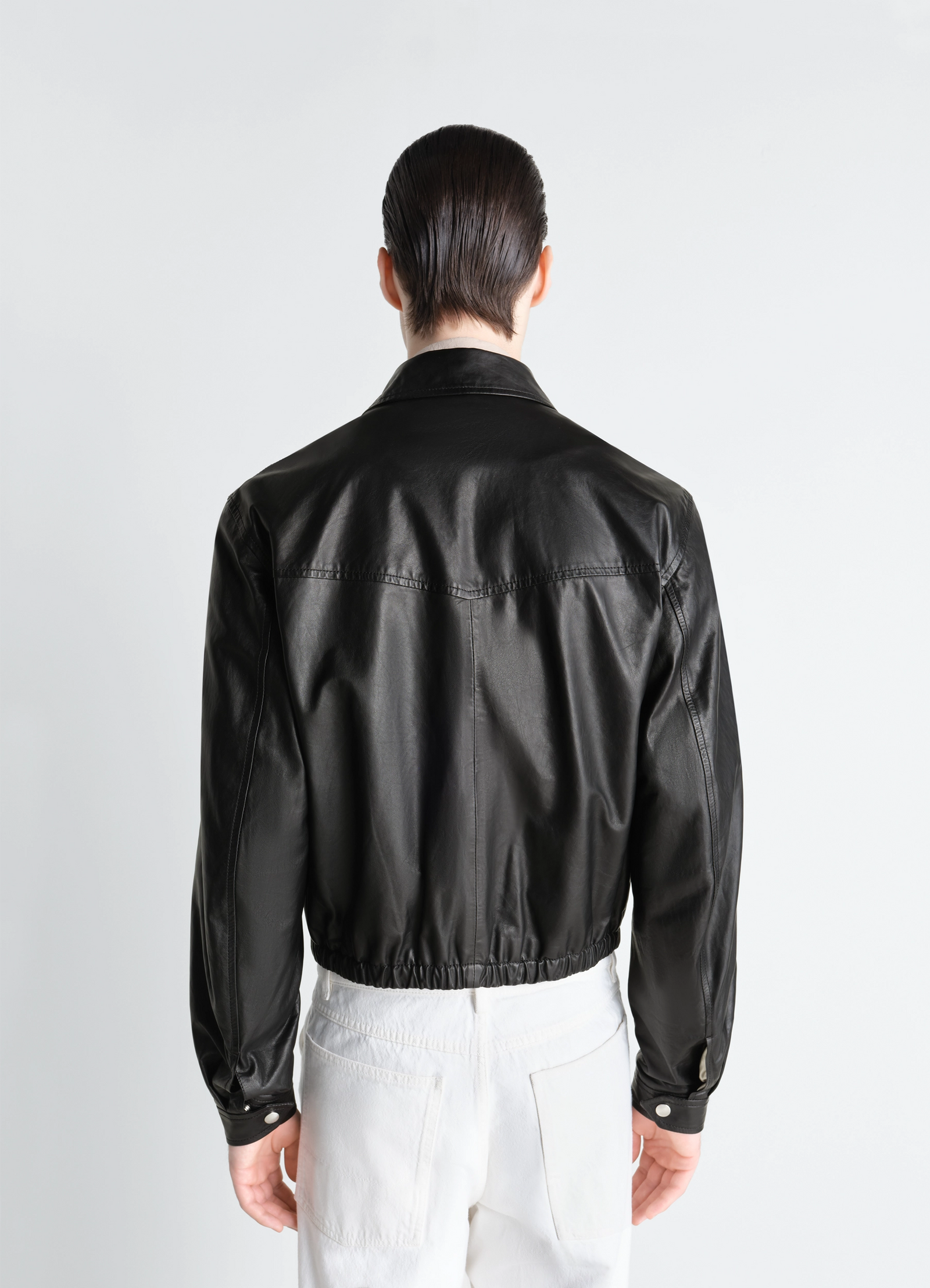 Lemaire biker blouson in paper leather, model shot, back view snap button cuffs