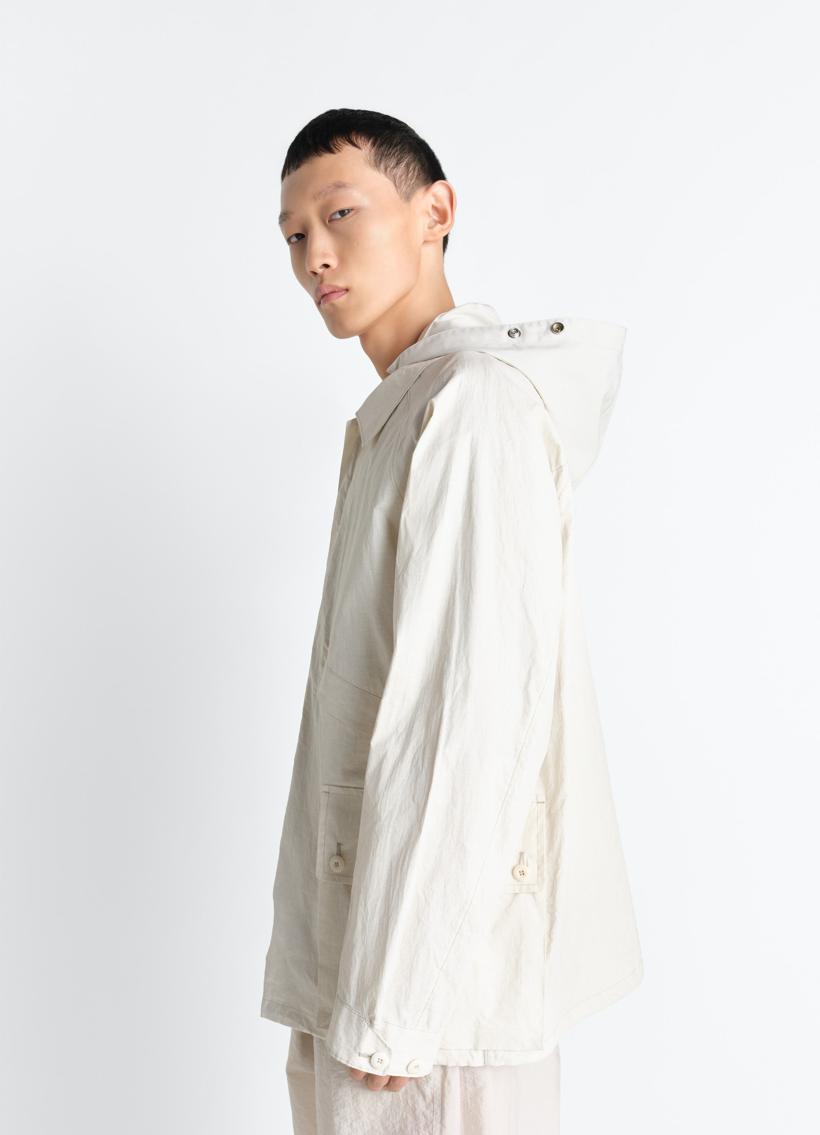 Lemaire rain jacket in coated technical linen, model shot, side profile view loose fit natural drape