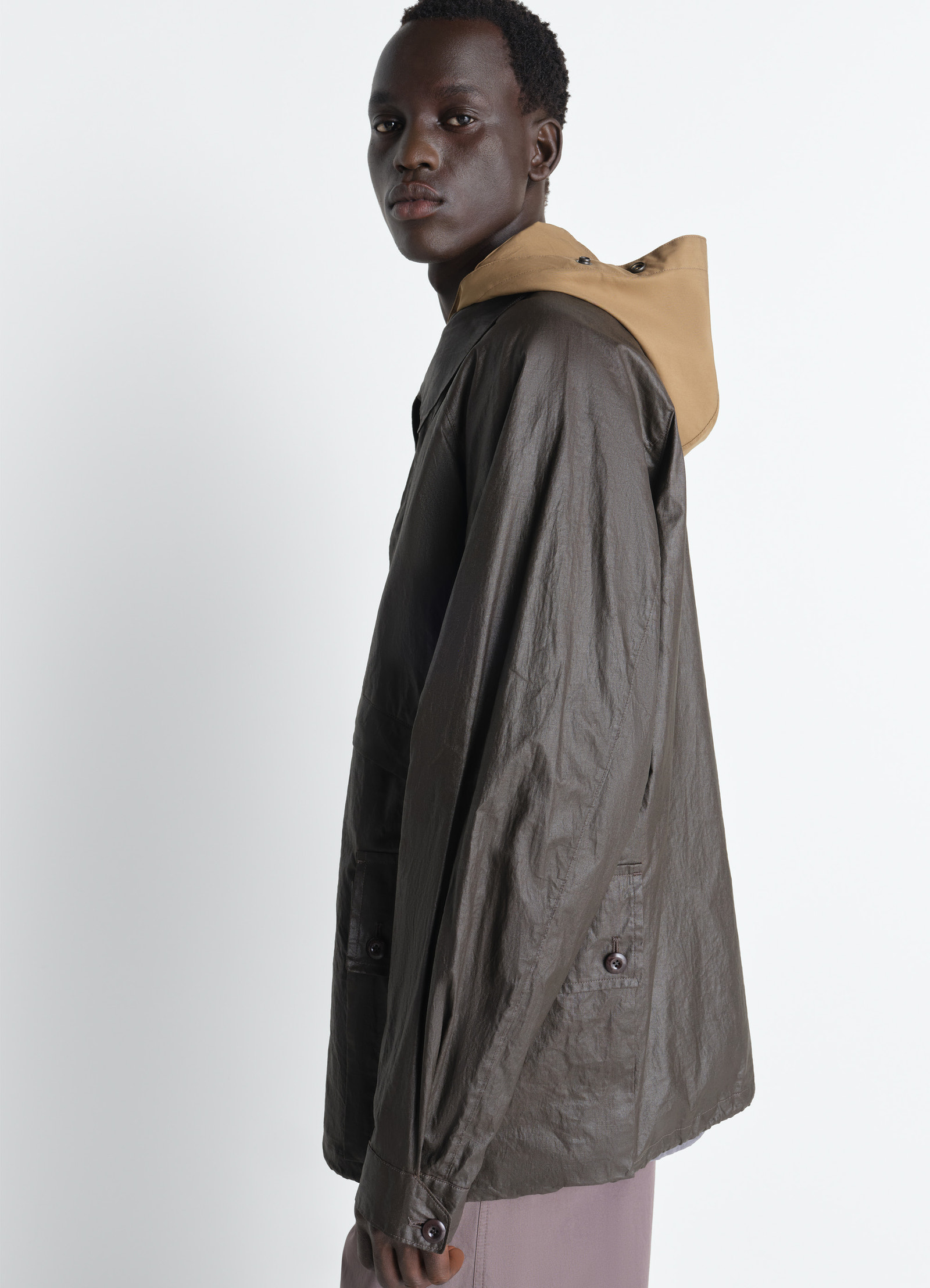 Lemaire rain jacket in coated technical linen, model shot, side view dropped shoulder