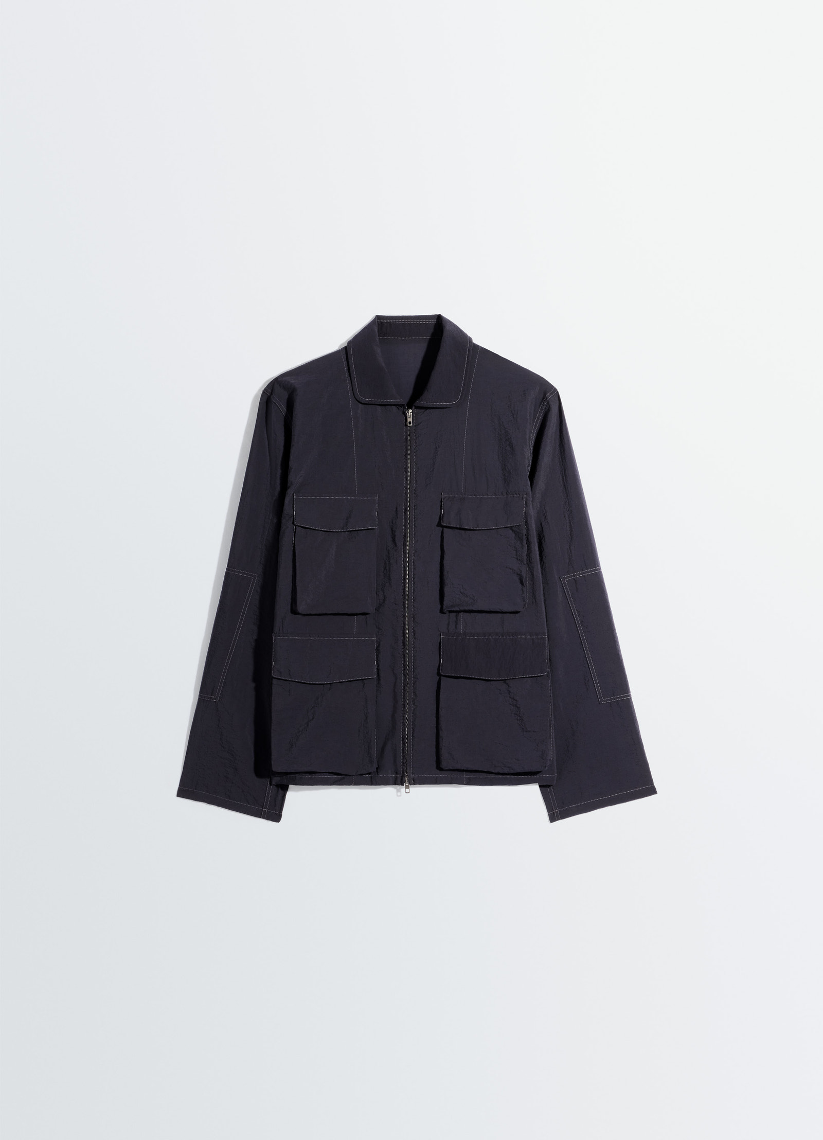 3d pocket jacket in washed technical cotton, product shot, angled top-down view pointed collar detail