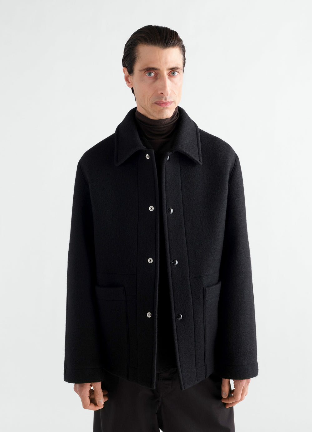 Utility jacket in black heavy wool cloth LEMAIRE worn by a model front view on white background
