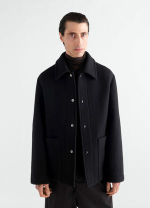 Utility jacket in black heavy wool cloth lemaire worn by a model front view on white background