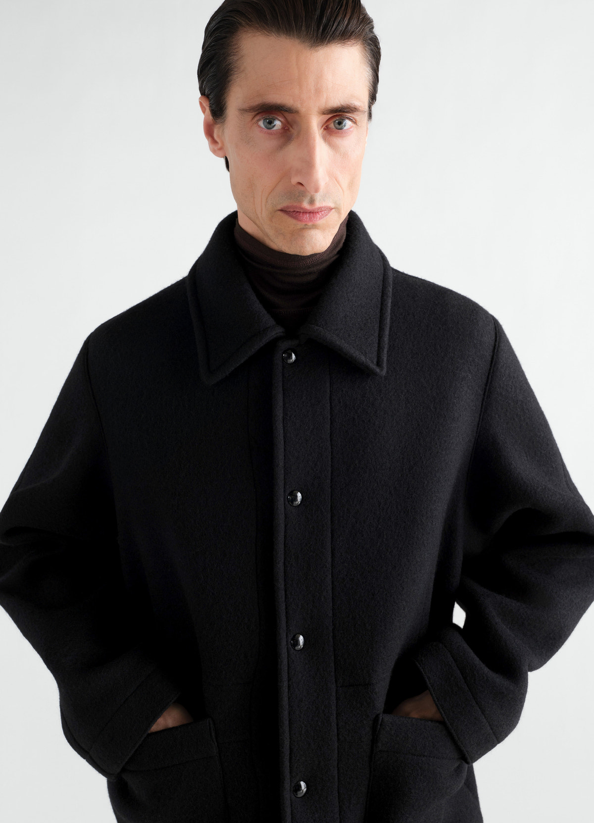 Utility jacket black heavy wool cloth with buttons worn by a model lemaire front view