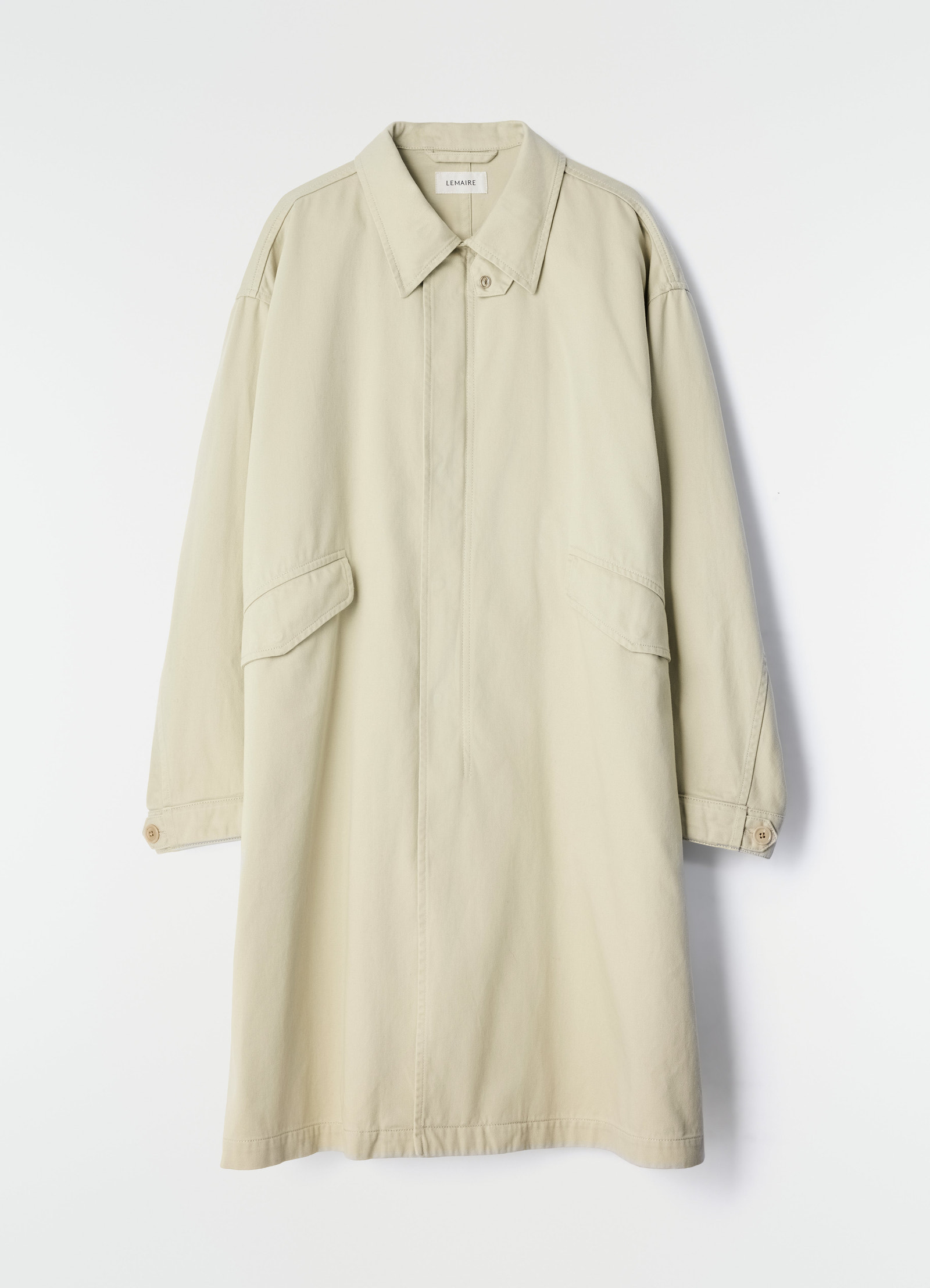 Military parka in beige heavy cotton satin by lemaire flat lay on white background with flap pockets