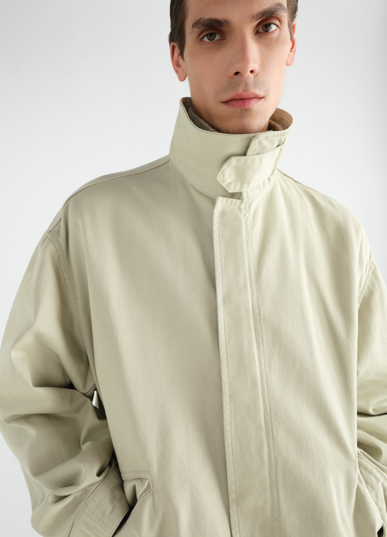 Military parka in beige heavy cotton satin with high stand collar worn by model lemaire front view
