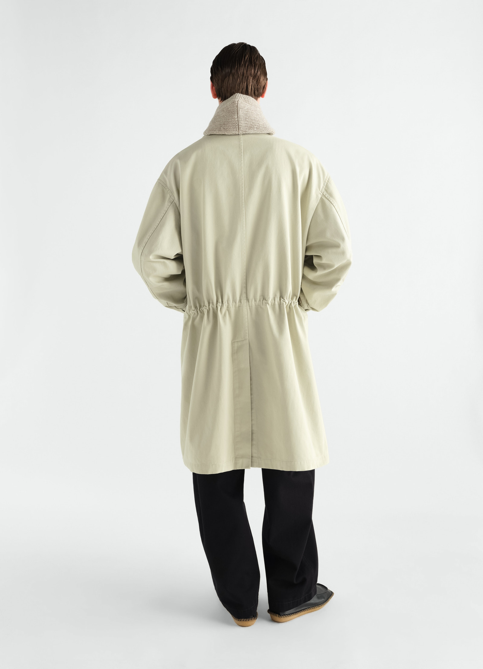 Military parka in beige heavy cotton satin with beige collar by lemaire worn by a model back view