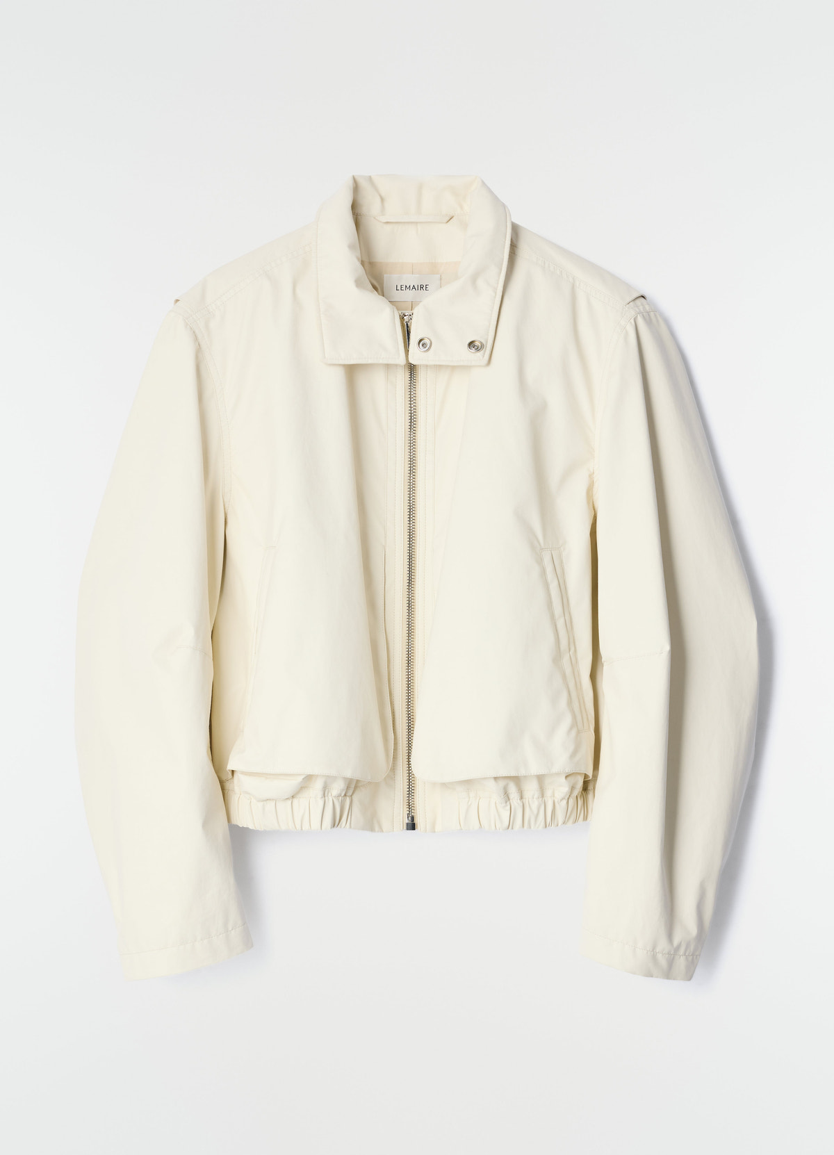 Zipped blouson in off-white waterproof cotton by lemaire front flat lay on white background