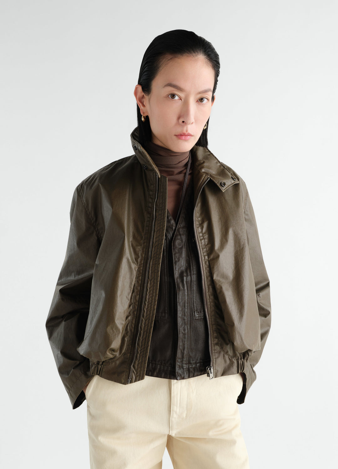 Zipped waterproof cotton blouson in olive green worn by model front view LEMAIRE