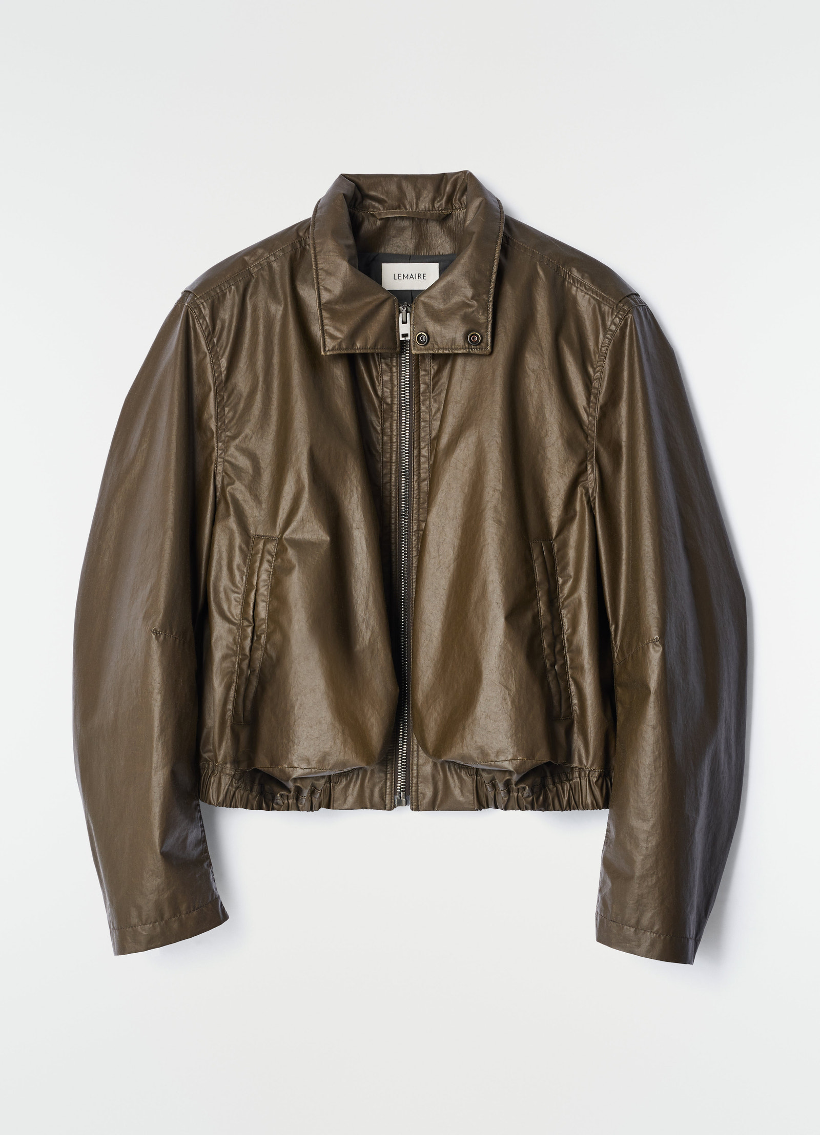 Zipped brown waterproof cotton blouson with elastic hem by lemaire on plain white background
