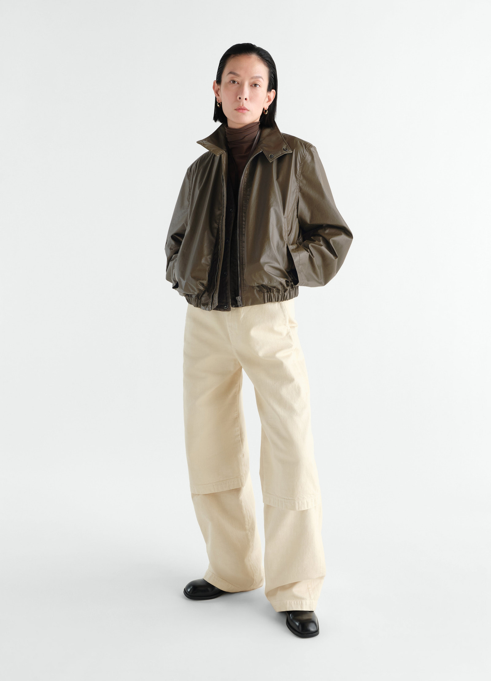Zipped waterproof cotton blouson in olive brown by lemaire worn by model front view styled look