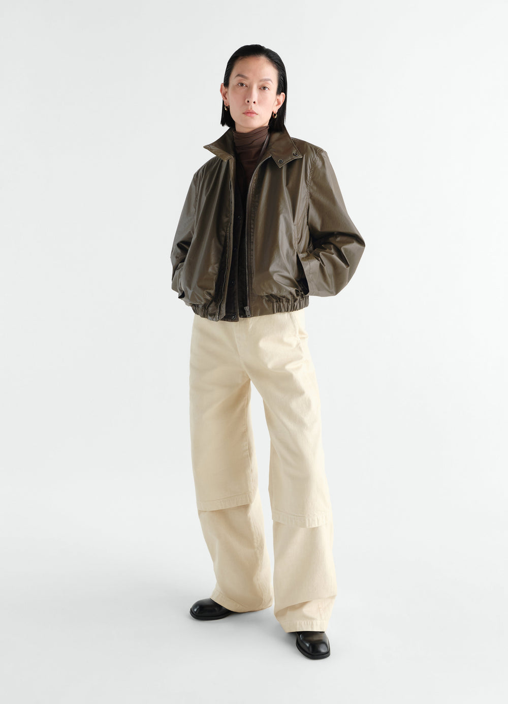 Zipped waterproof cotton blouson in olive brown by LEMAIRE worn by model front view styled look