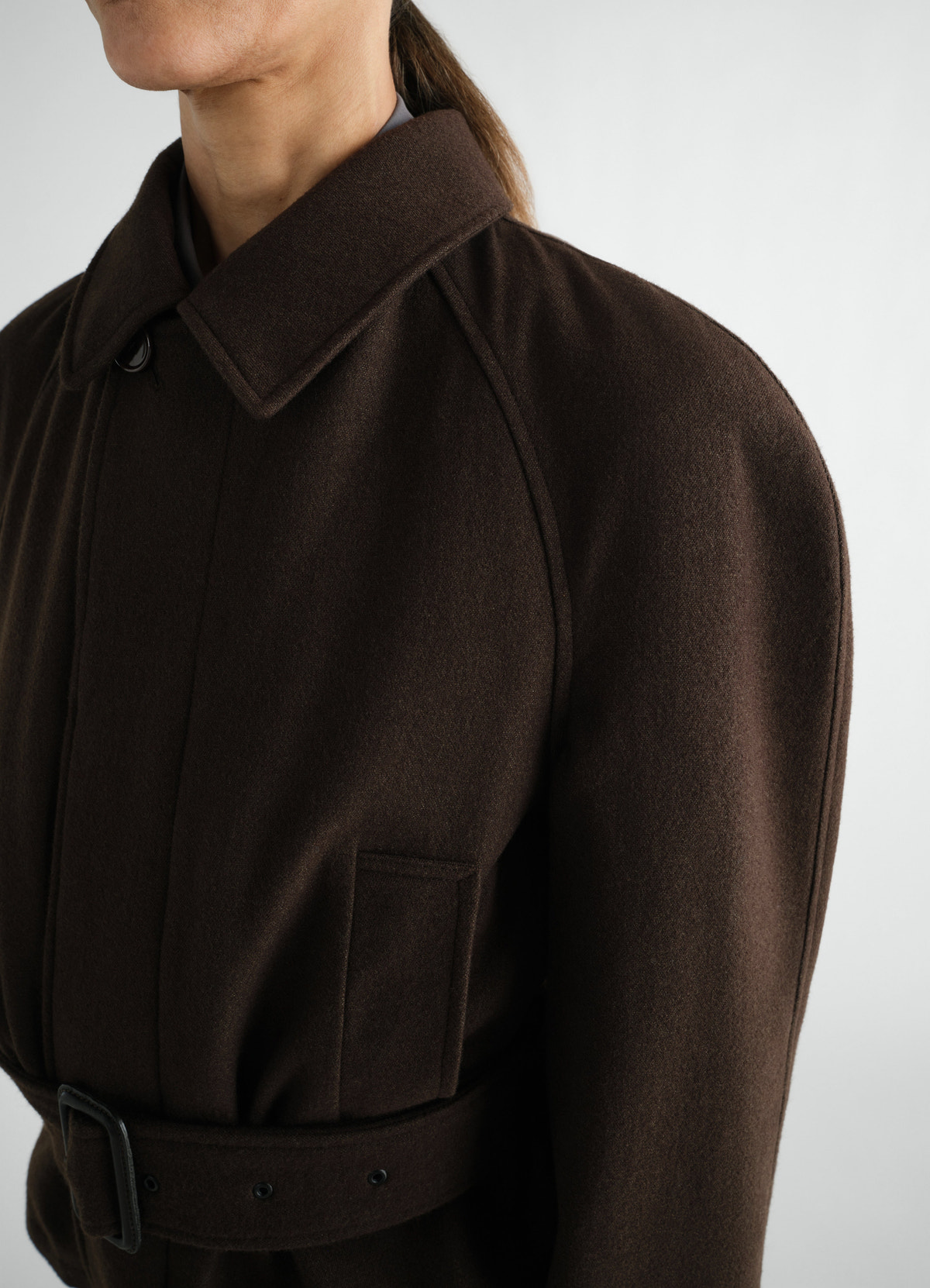 Short brown wool and cotton twill belted coat by lemaire worn by a model close-up front side