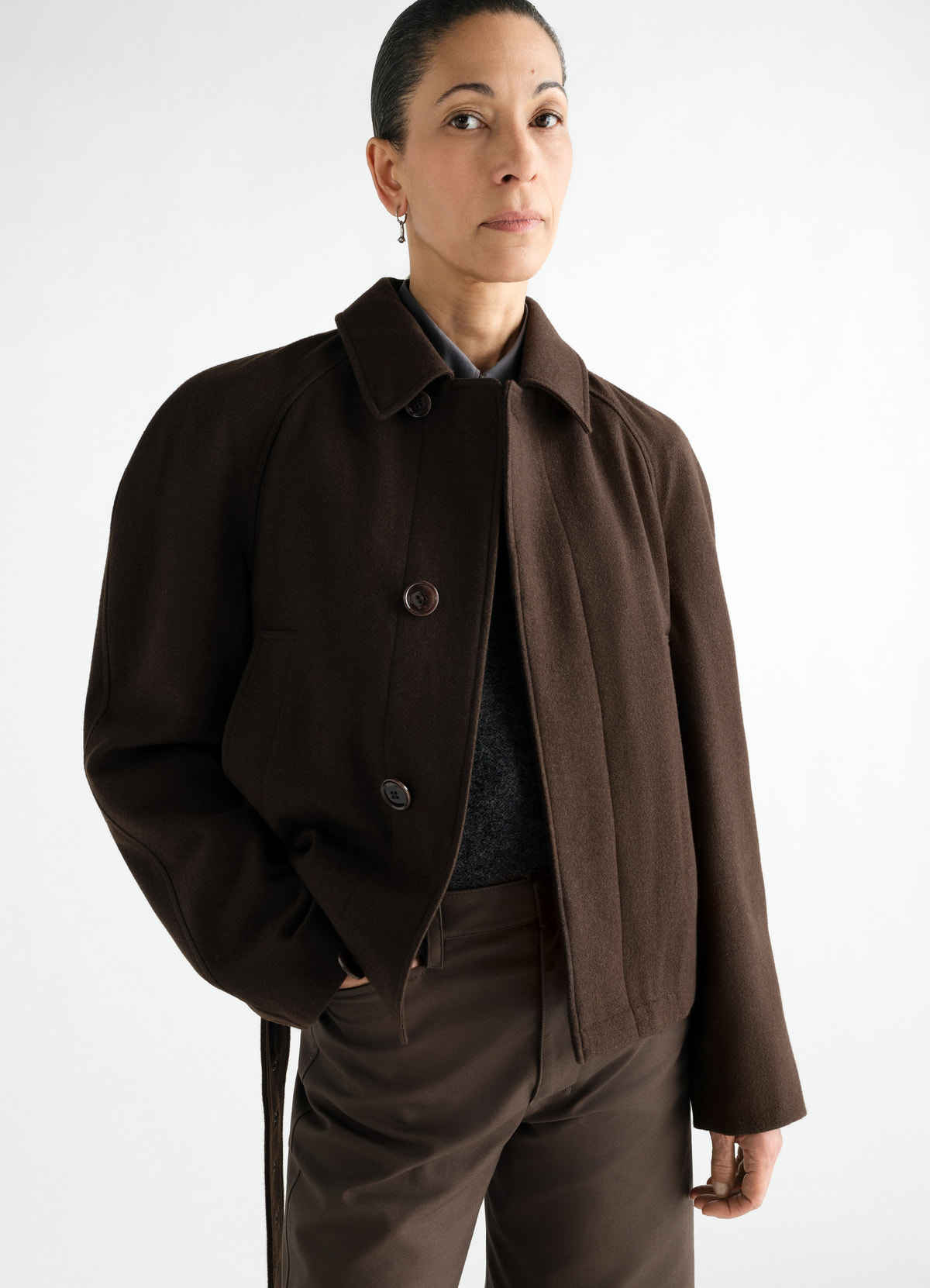 Short brown wool and cotton twill belted coat lemaire worn by a model front view with pockets and buttons