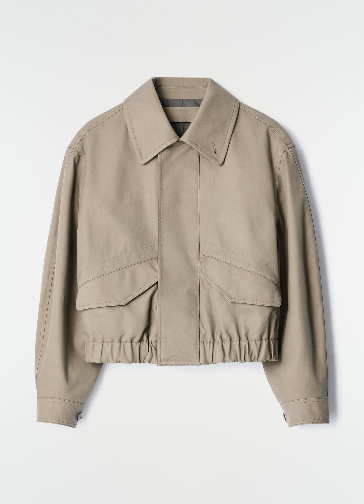 Short beige heavy cotton twill blouson with front pockets and elastic hem by lemaire on plain white background