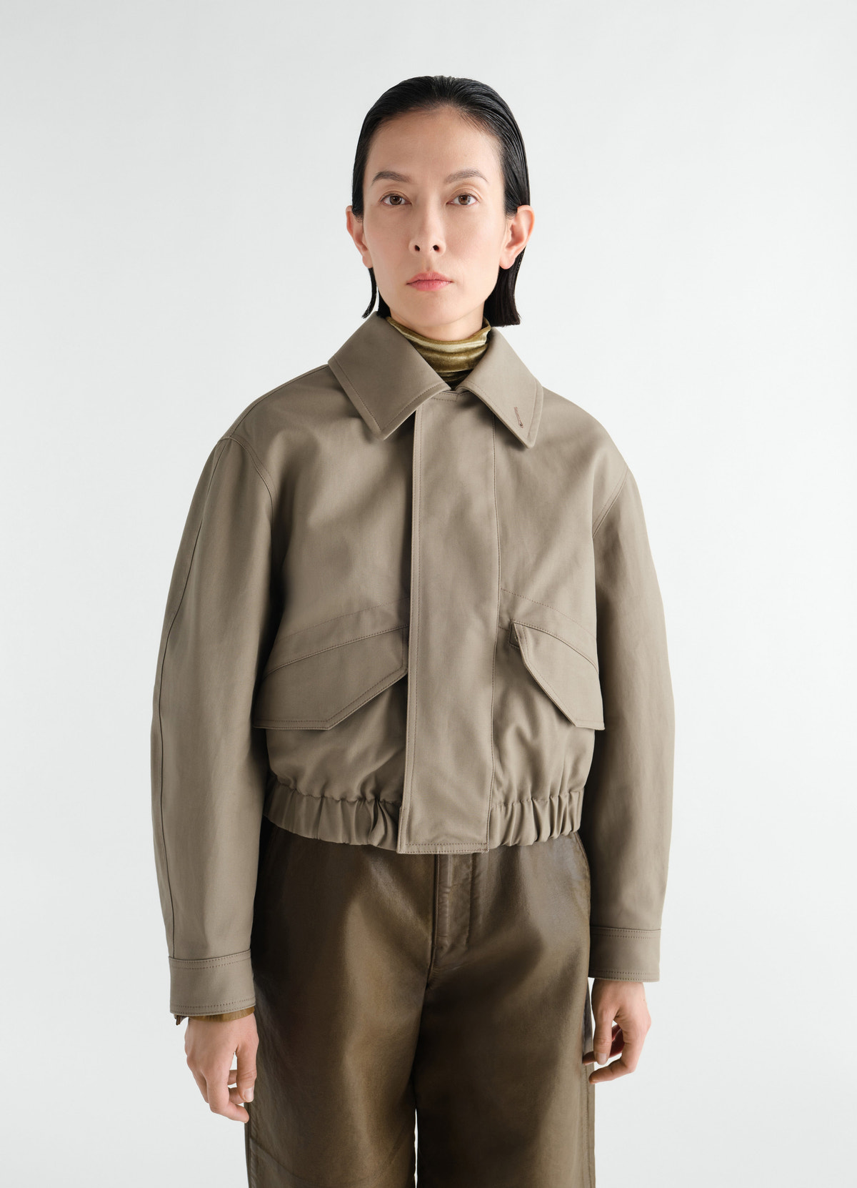Short cotton twill blouson in khaki with elastic hem worn by a model lemaire front view