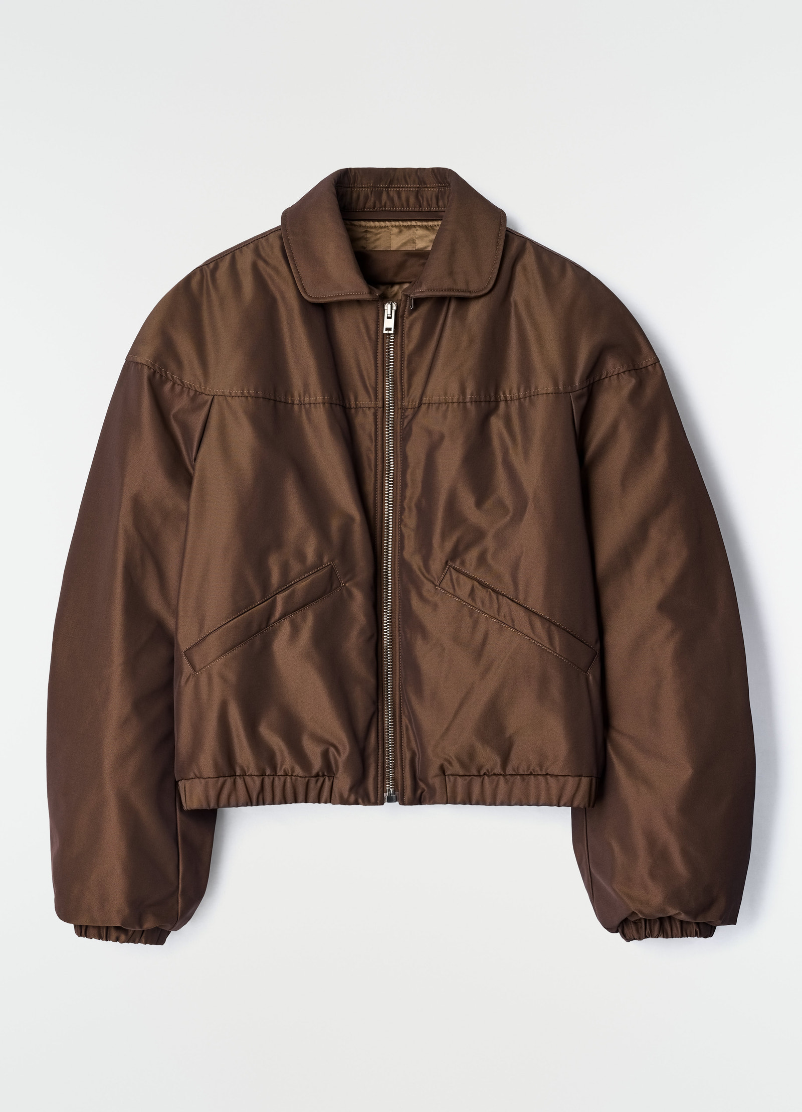 Quilted brown water-repellent canvas blouson with zip and elastic cuffs by lemaire flat lay on white background