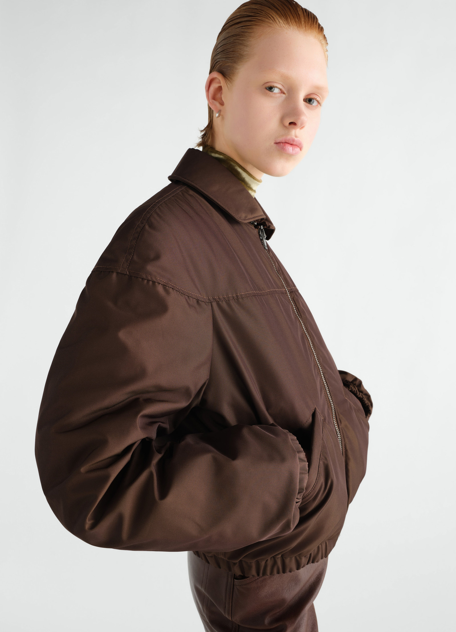 Quilted brown water-repellent canvas blouson worn by model side view lemaire
