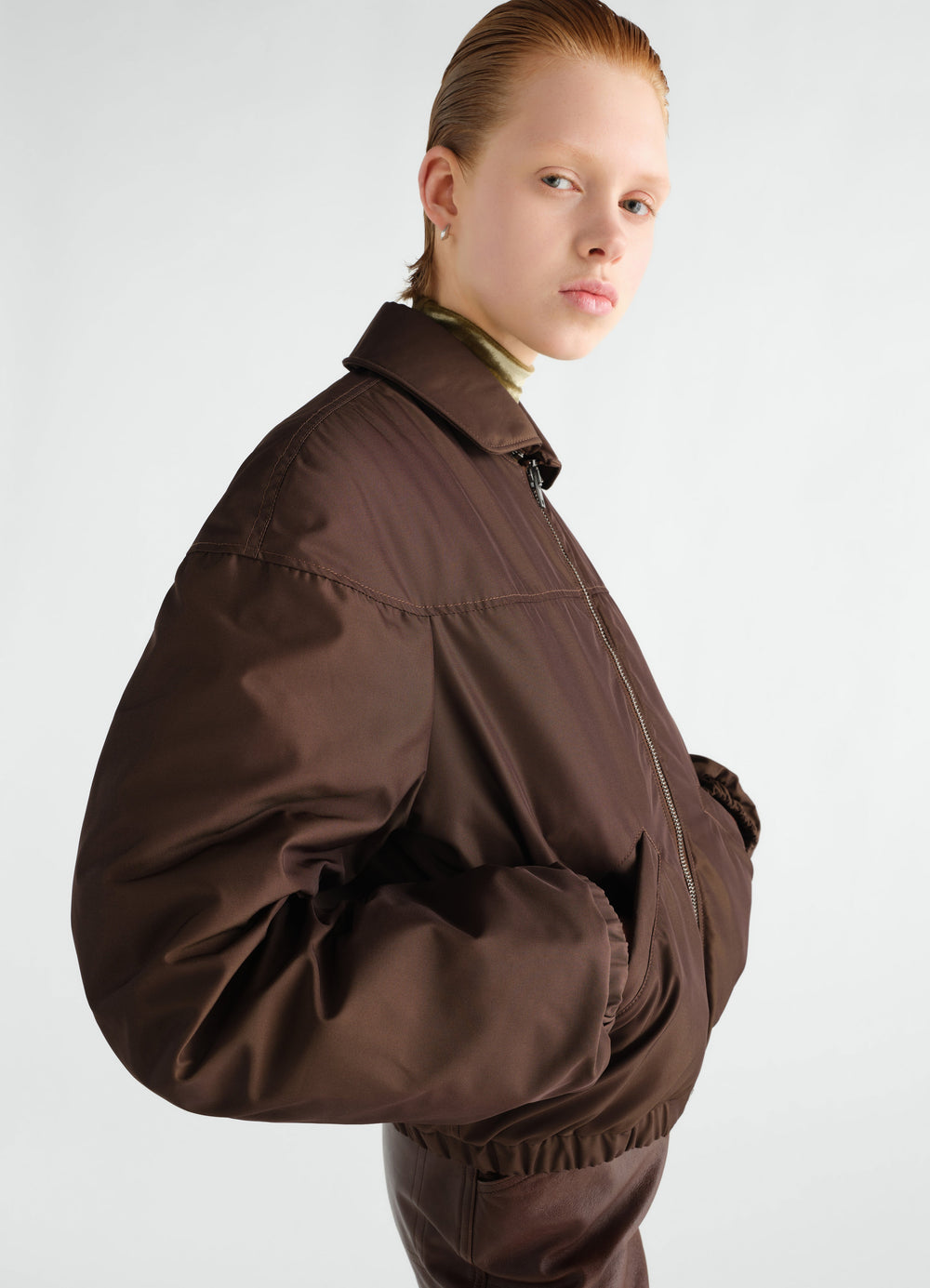 Quilted brown water-repellent canvas blouson worn by model side view LEMAIRE