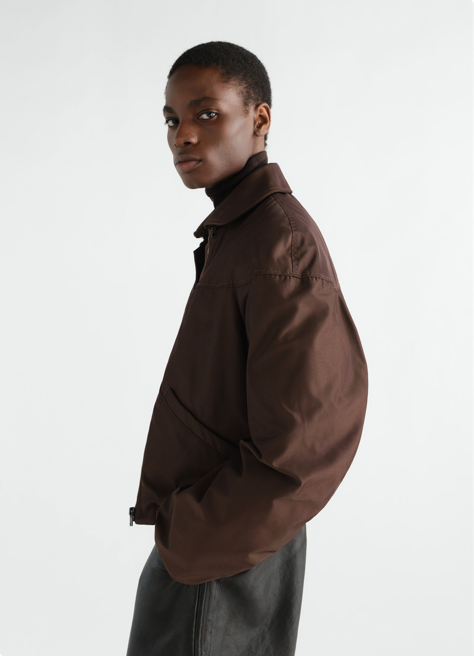 Quilted brown water-repellent canvas blouson lemaire worn by model side view with collar and zip closure