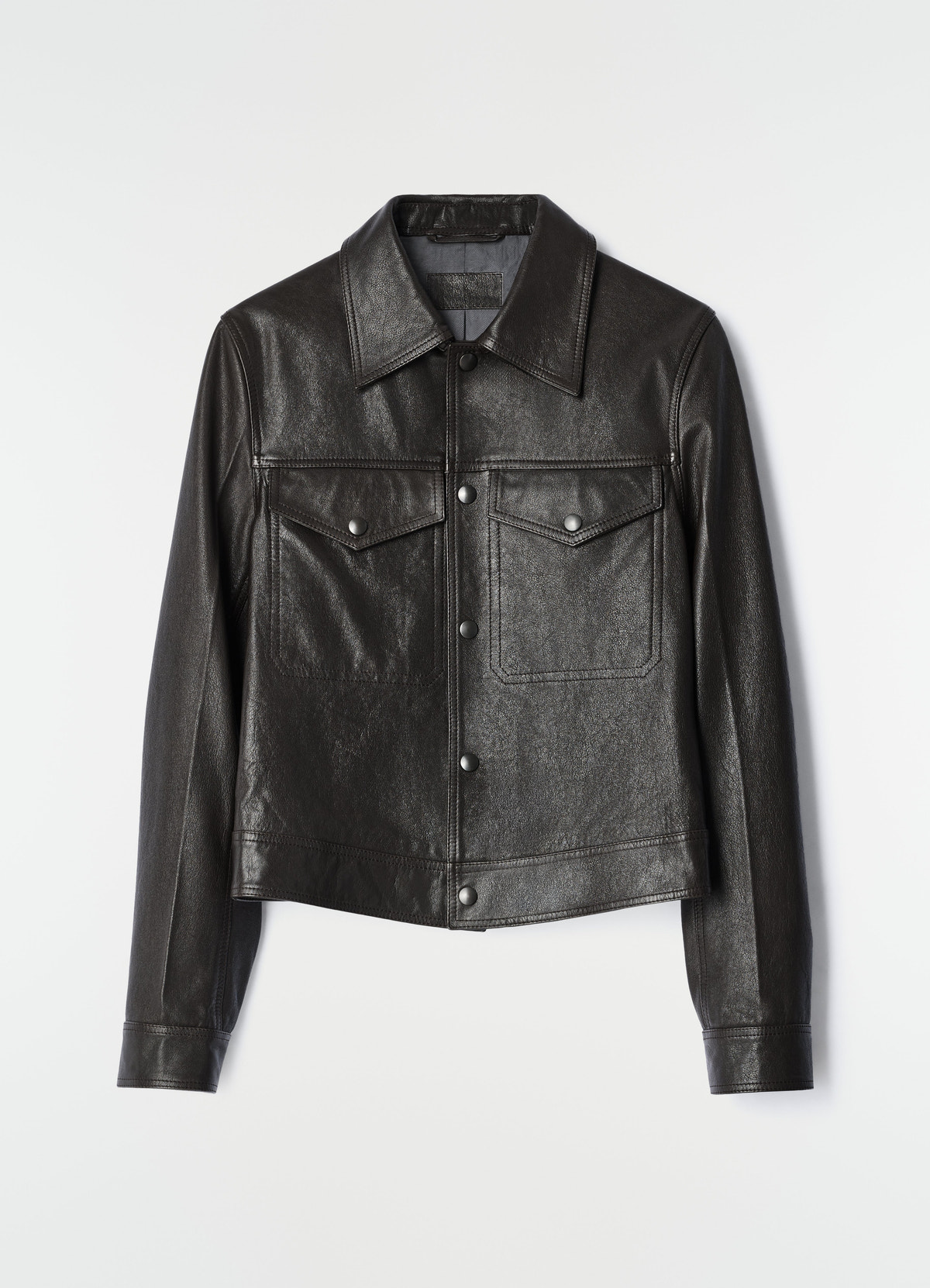 Black glossy leather trucker jacket with snap buttons and chest pockets lemaire flat lay on white background