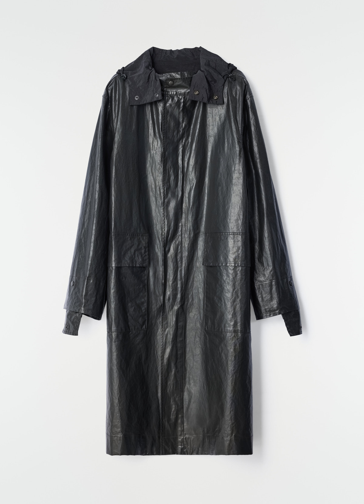 Long black coated linen and cotton blend raincoat by lemaire on plain white background front view