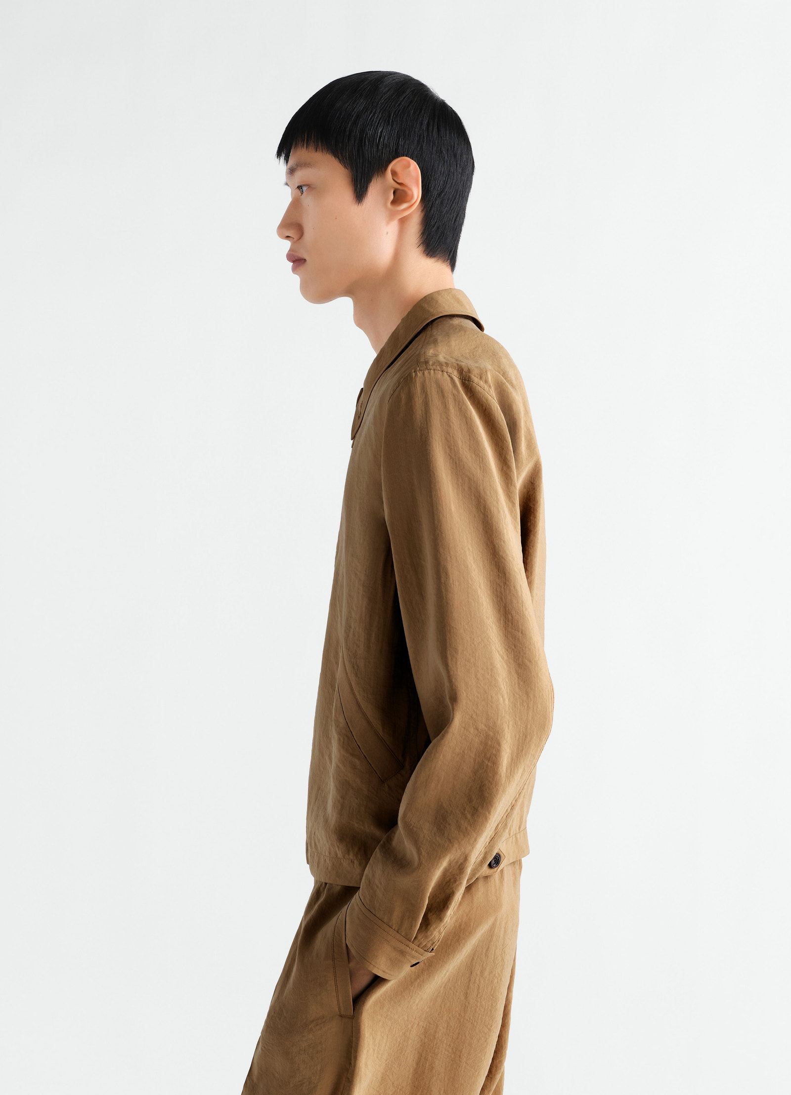 Light brown dry silk zipped blouson lemaire side view worn by model with matching trousers on white background