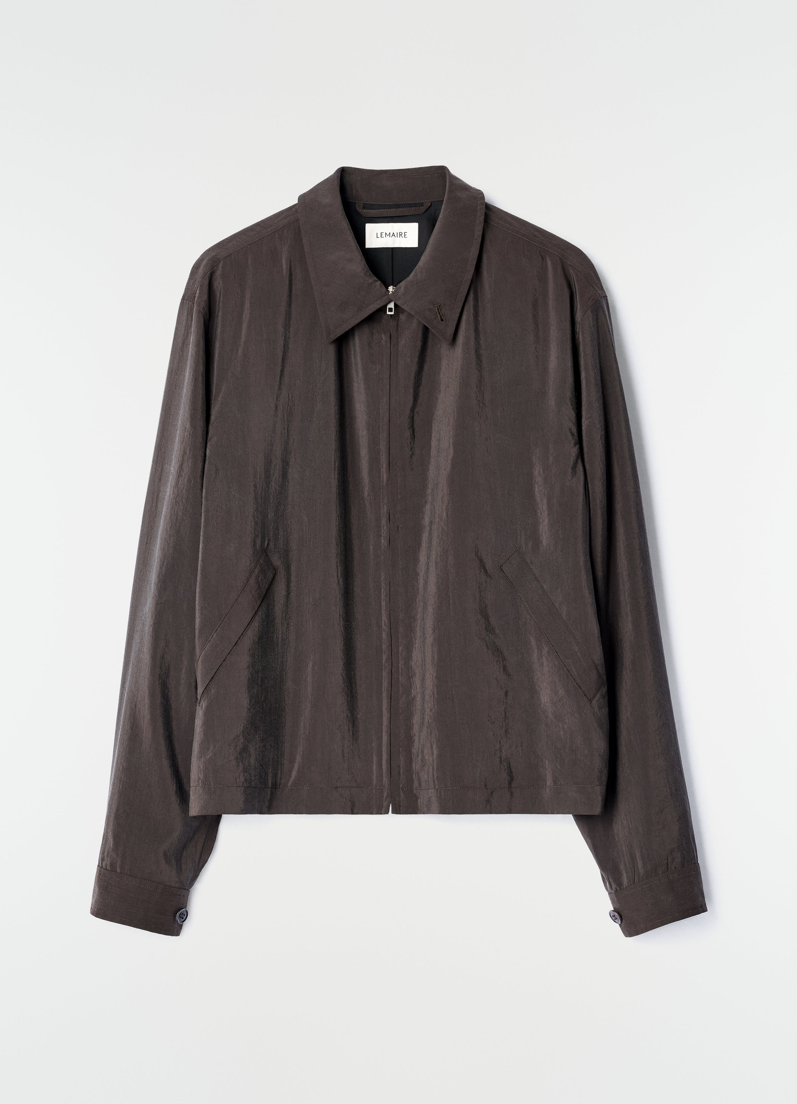 Light brown dry silk zipped blouson with collar by lemaire on plain white background front view