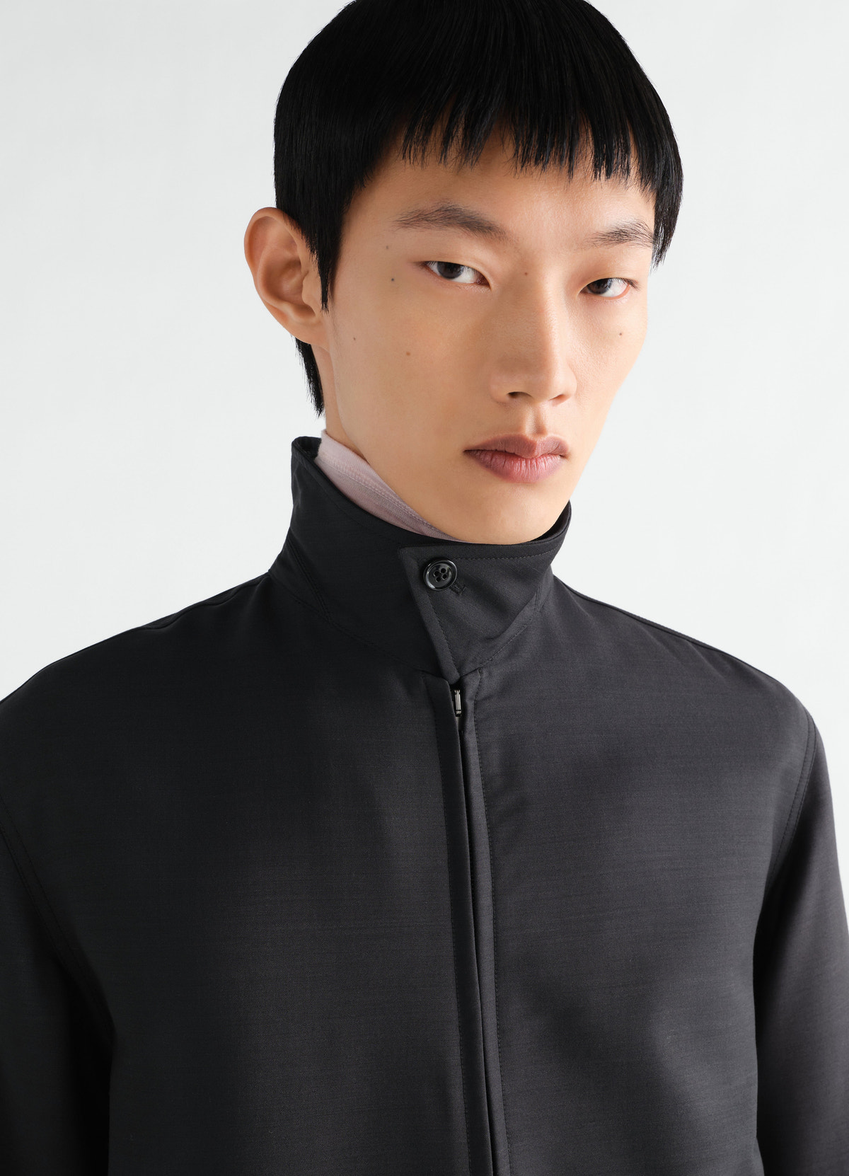 Zipped black wool and viscose blouson with high collar worn by model lemaire front close-up