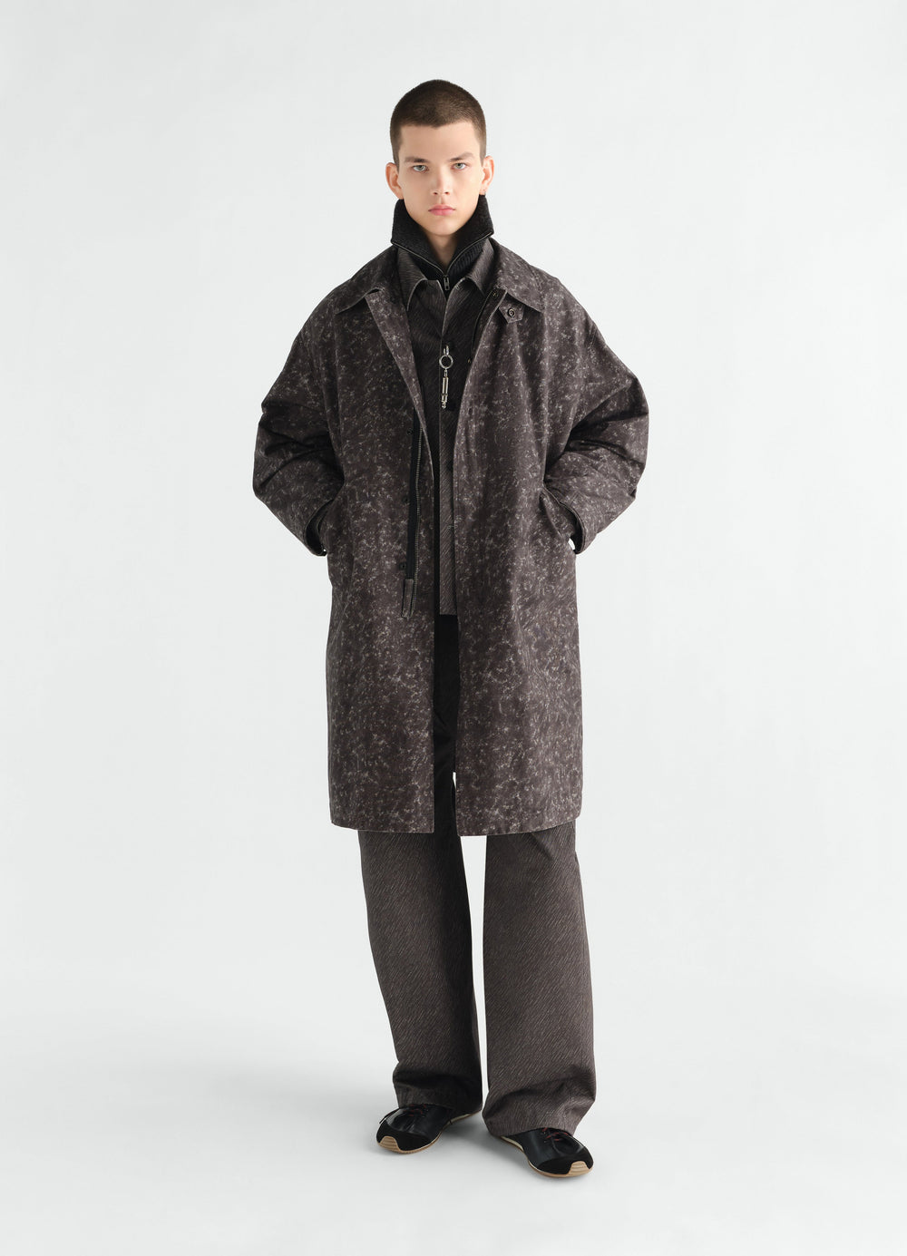 Military parka in brown storm printed cotton by LEMAIRE worn by model front view full body