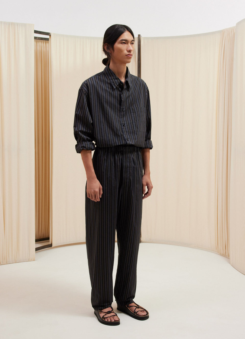 Lemaire Relaxed Pants in Striped Cotton Silk, model shot, Three-quarter view Relaxed fit with pleats