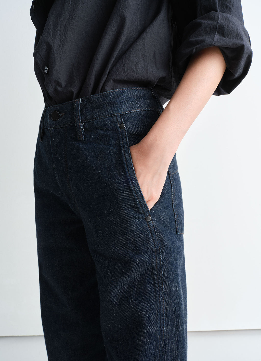 Lemaire Twisted Pants in Deep Indigo Heavy Denim, model shot, close-up detail twisted seams visible