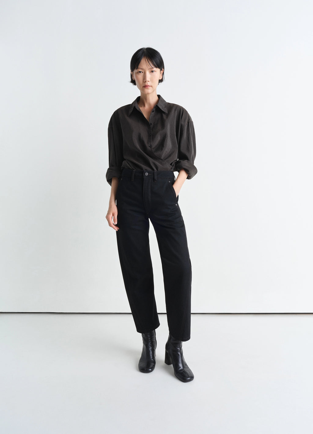 Lemaire Twisted Pants in Deep Black Heavy Denim, model shot, Front view Straight cut with twist seams