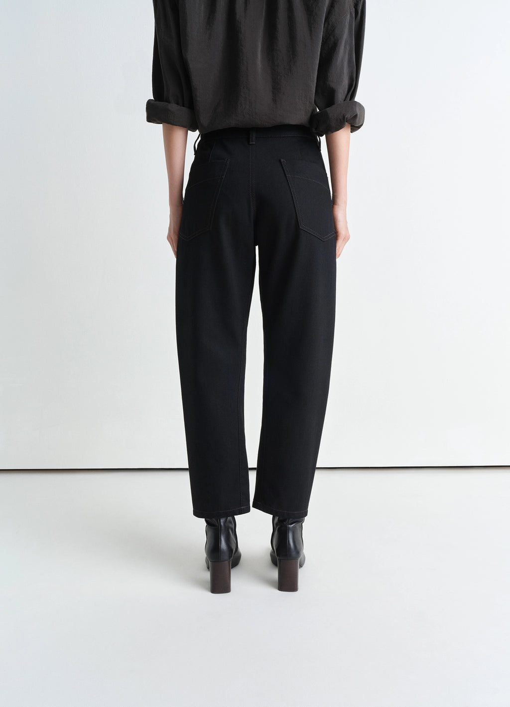 Lemaire Twisted Pants in Deep Black Heavy Denim, model shot, back view rear pockets, straight leg