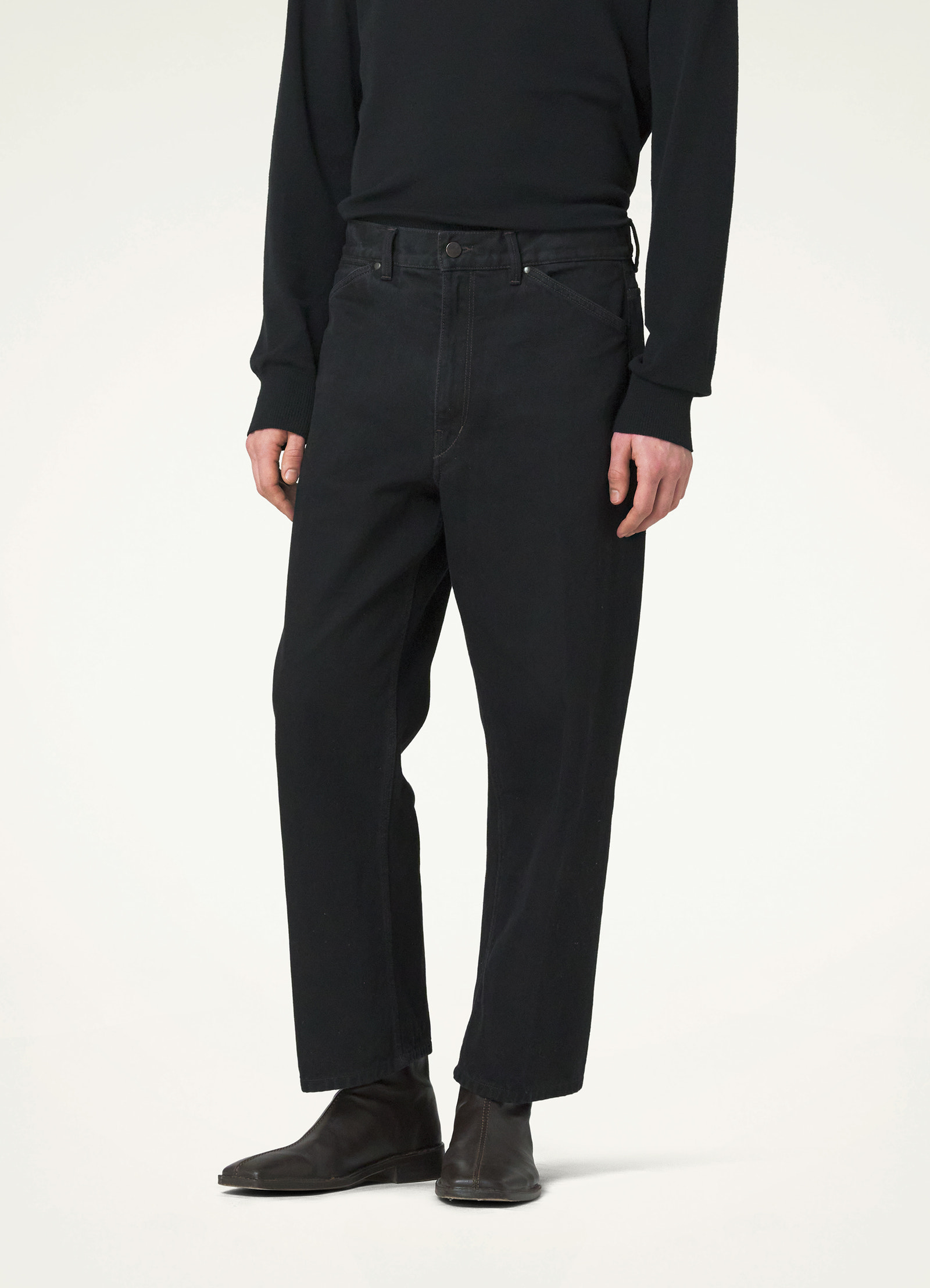 Lemaire curved 5 pocket pants in deep black heavy denim, model shot, side view relaxed fit ankle length
