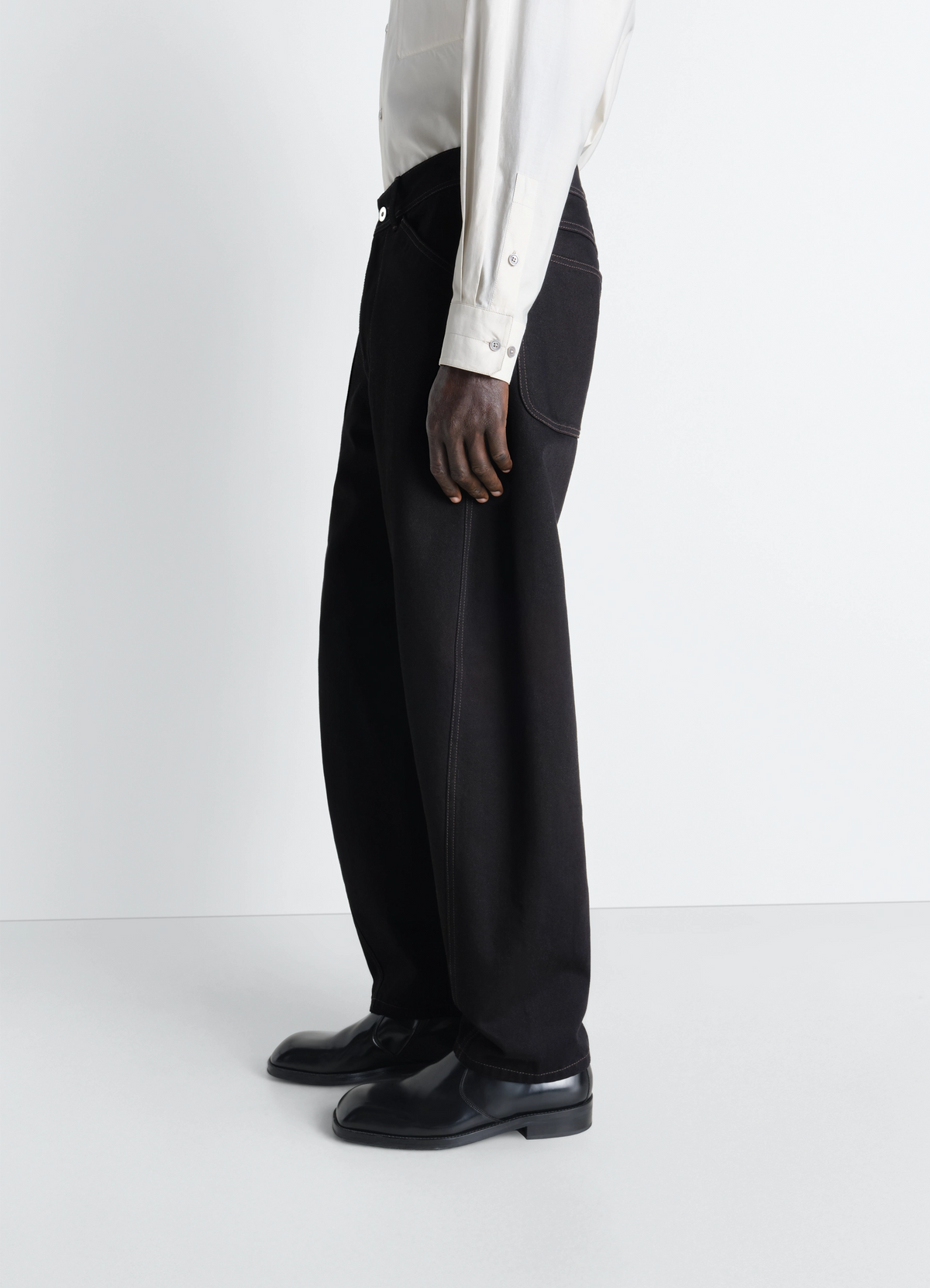 Lemaire Twisted Workwear Pants in Deep Black Denim, model shot, Full Body Front View Twisted Seams, Rounded Leg