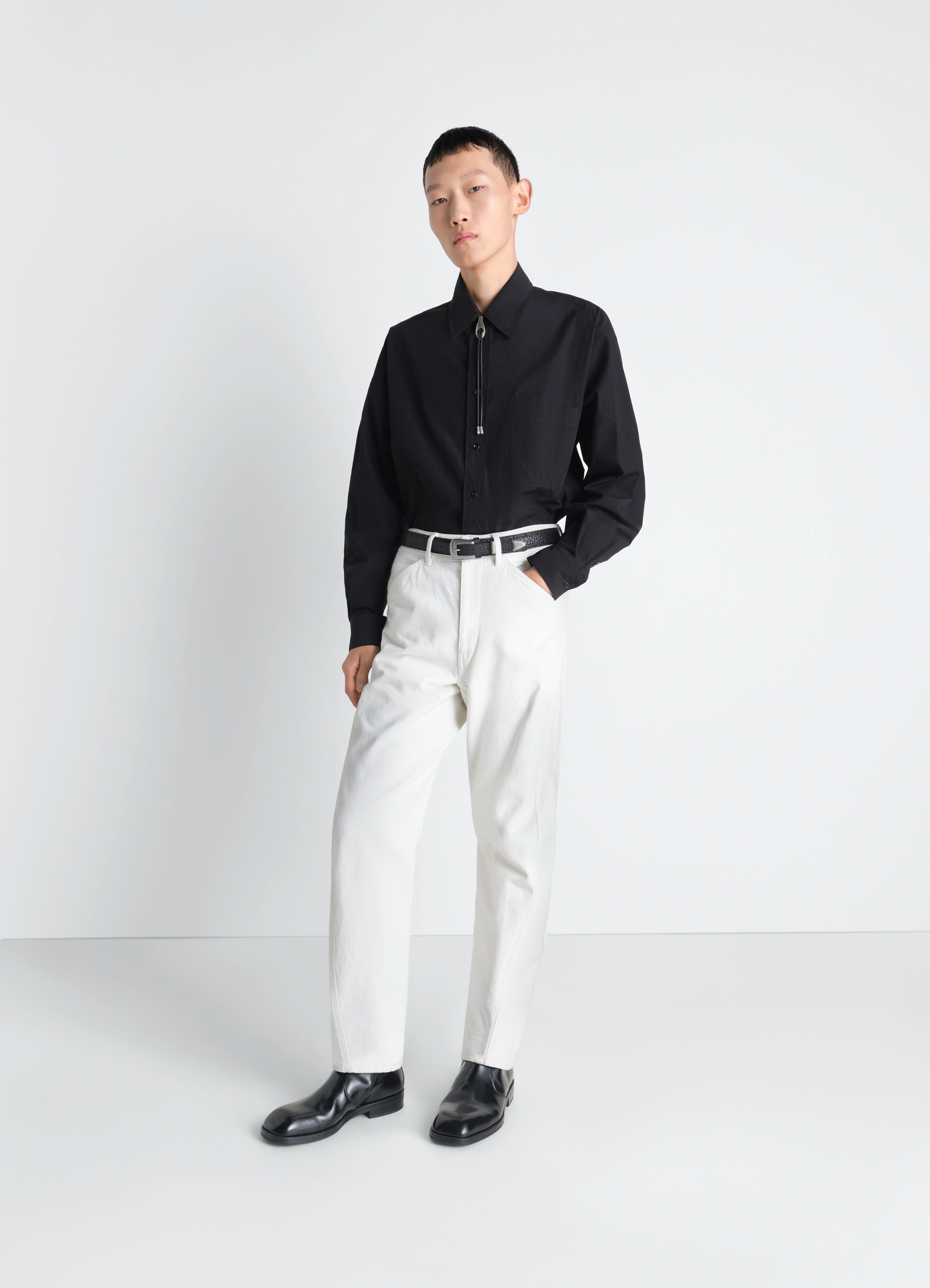 Twisted workwear pants in denim in thick compact bleached denim, model shot, front view utility trousers, wide leg