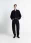 Lemaire Twisted Workwear Pants in Deep Black Thick Denim, model shot, Front view Twisted seams rounded leg