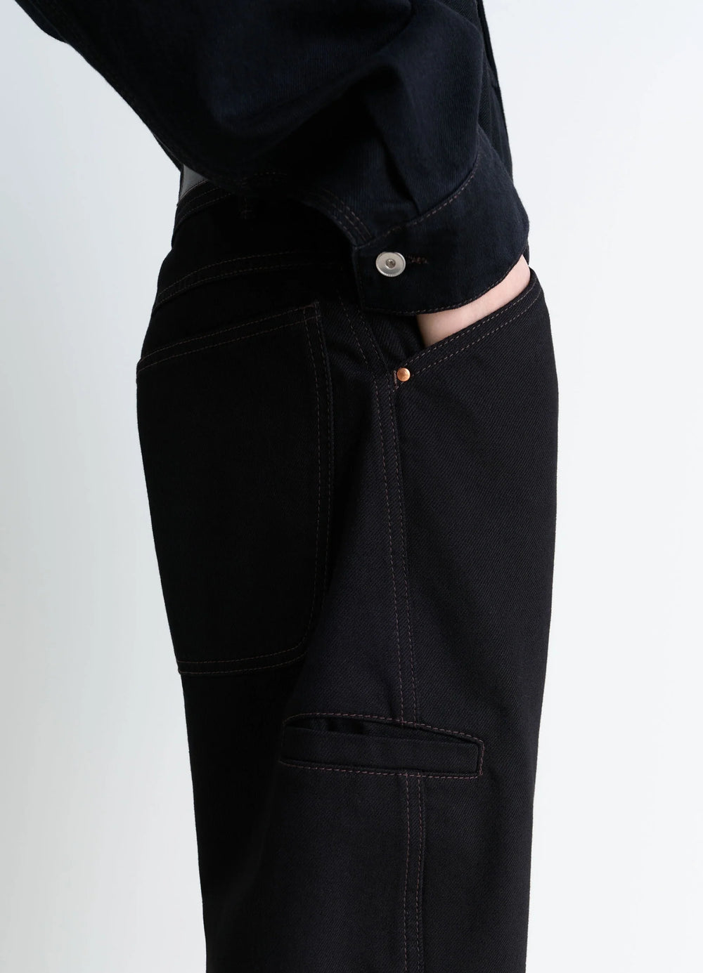 Lemaire Twisted Workwear Pants in Deep Black Thick Denim, model shot, close-up side detail utilitarian pocket seams
