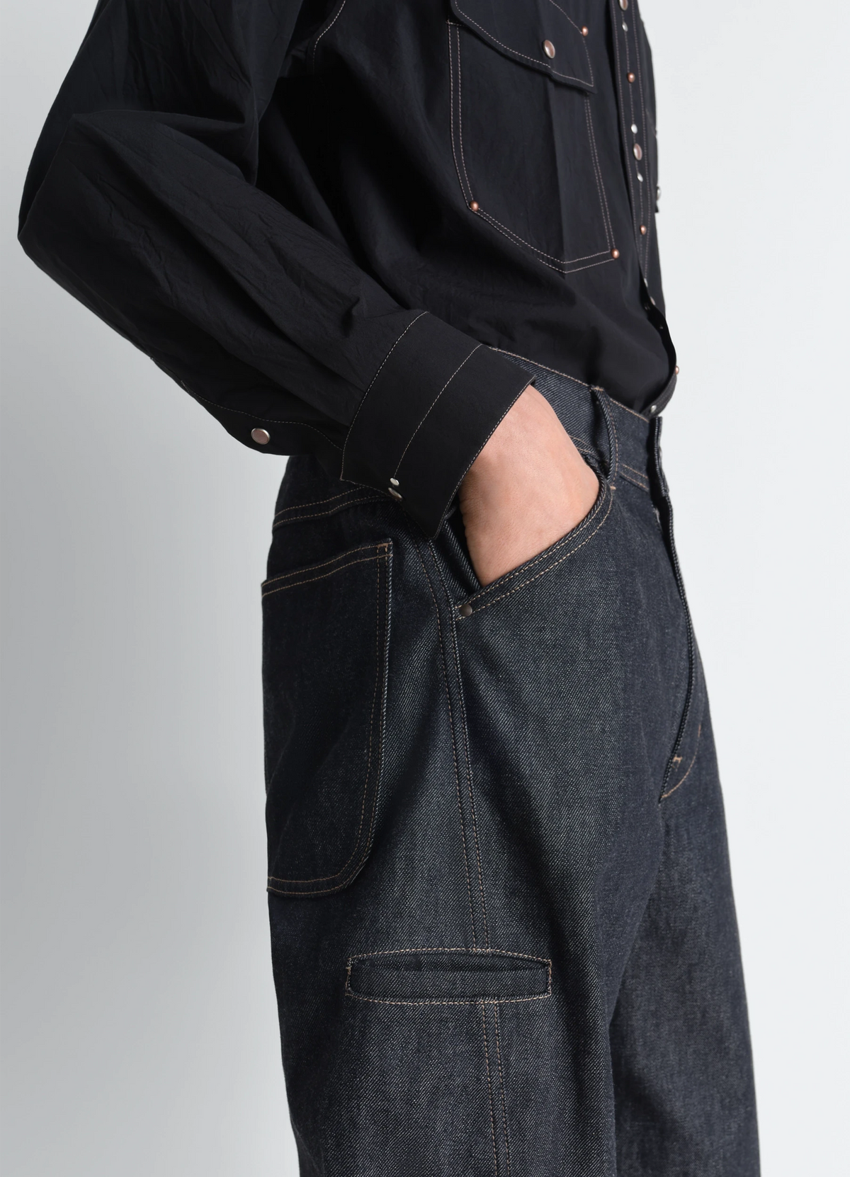Twisted Workwear Pants in yarn-dyed slate denim, model shot, front view twisted seams, rounded leg