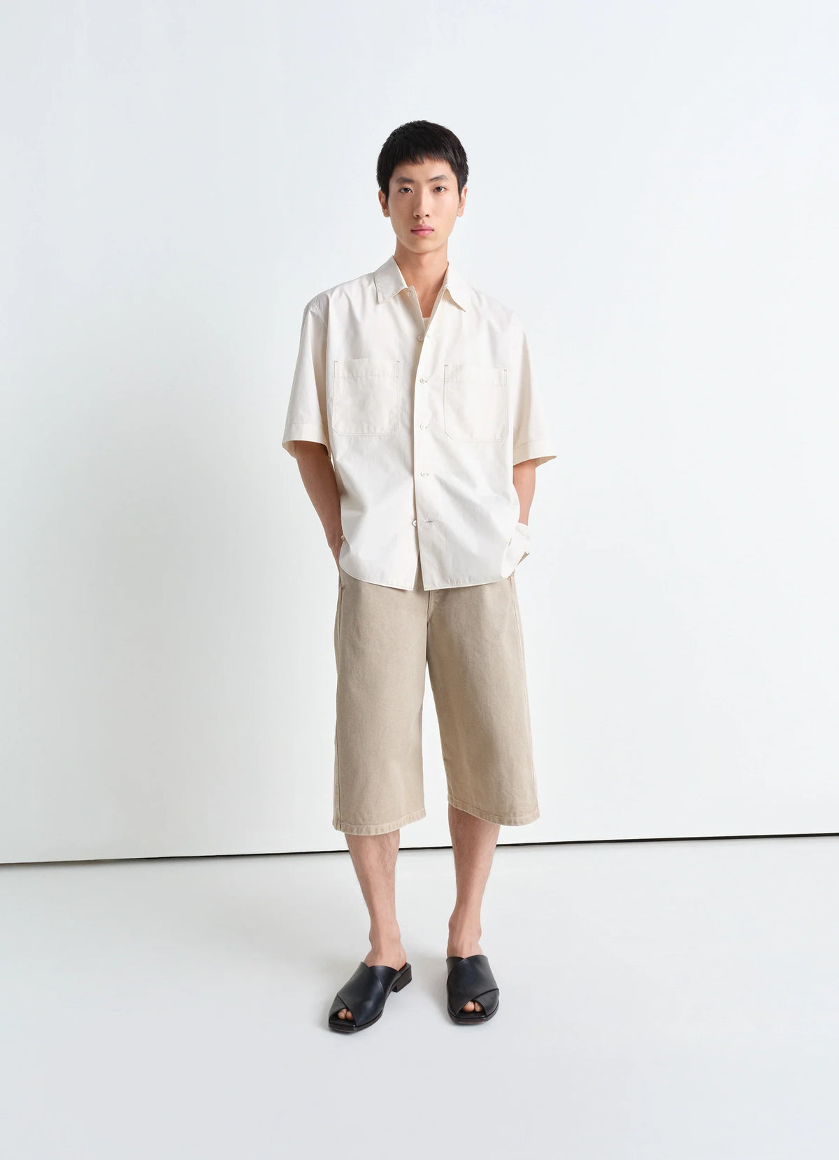 Lemaire Twisted Short in Heavy garment-dyed denim, model shot, front view curved leg porte