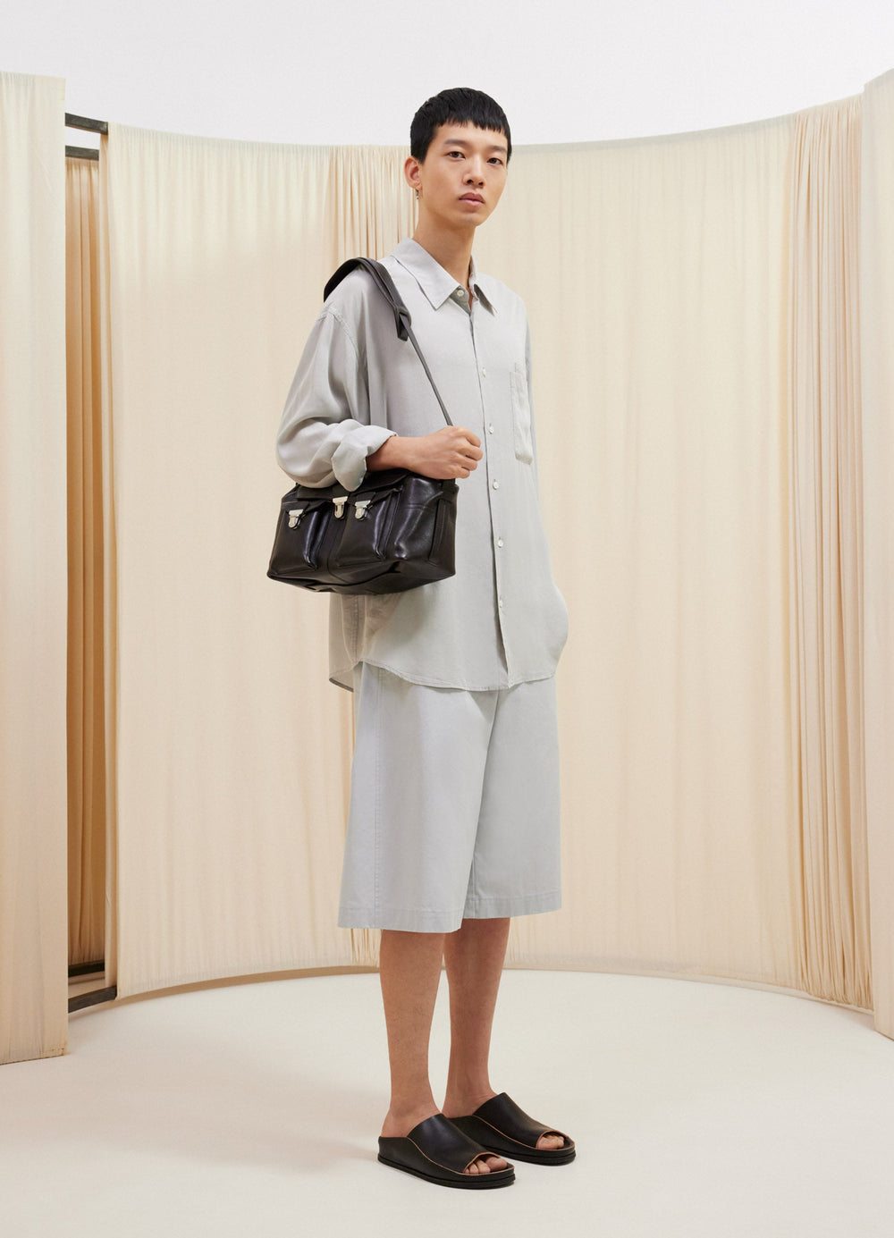 Lemaire Maxi Bermuda in Lightweight Cotton Twill, model shot, front view wide leg, belt adjusters