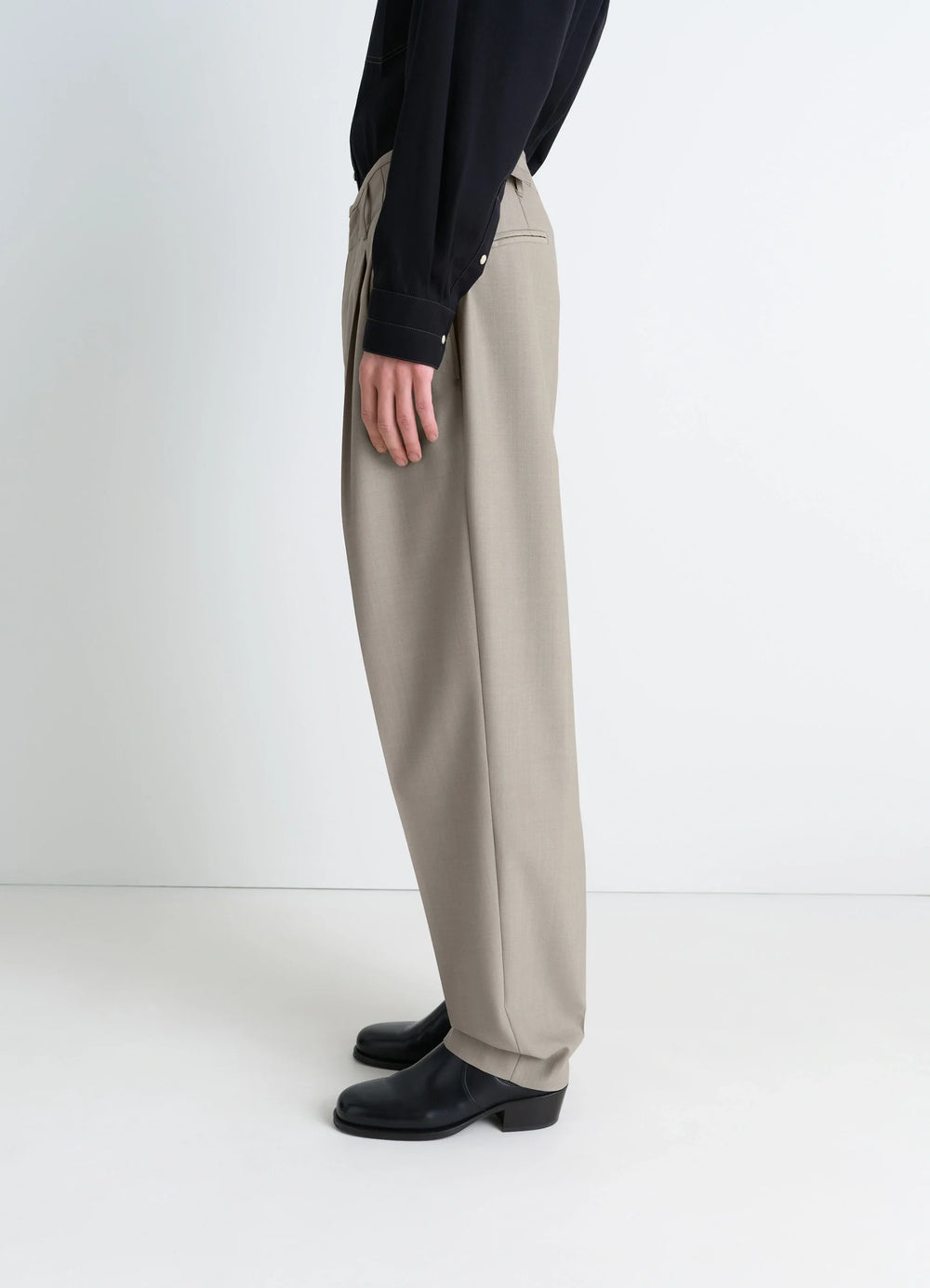 Lemaire Pleated Pants in Tropical wool-blend suiting, model shot, profile view straight leg
