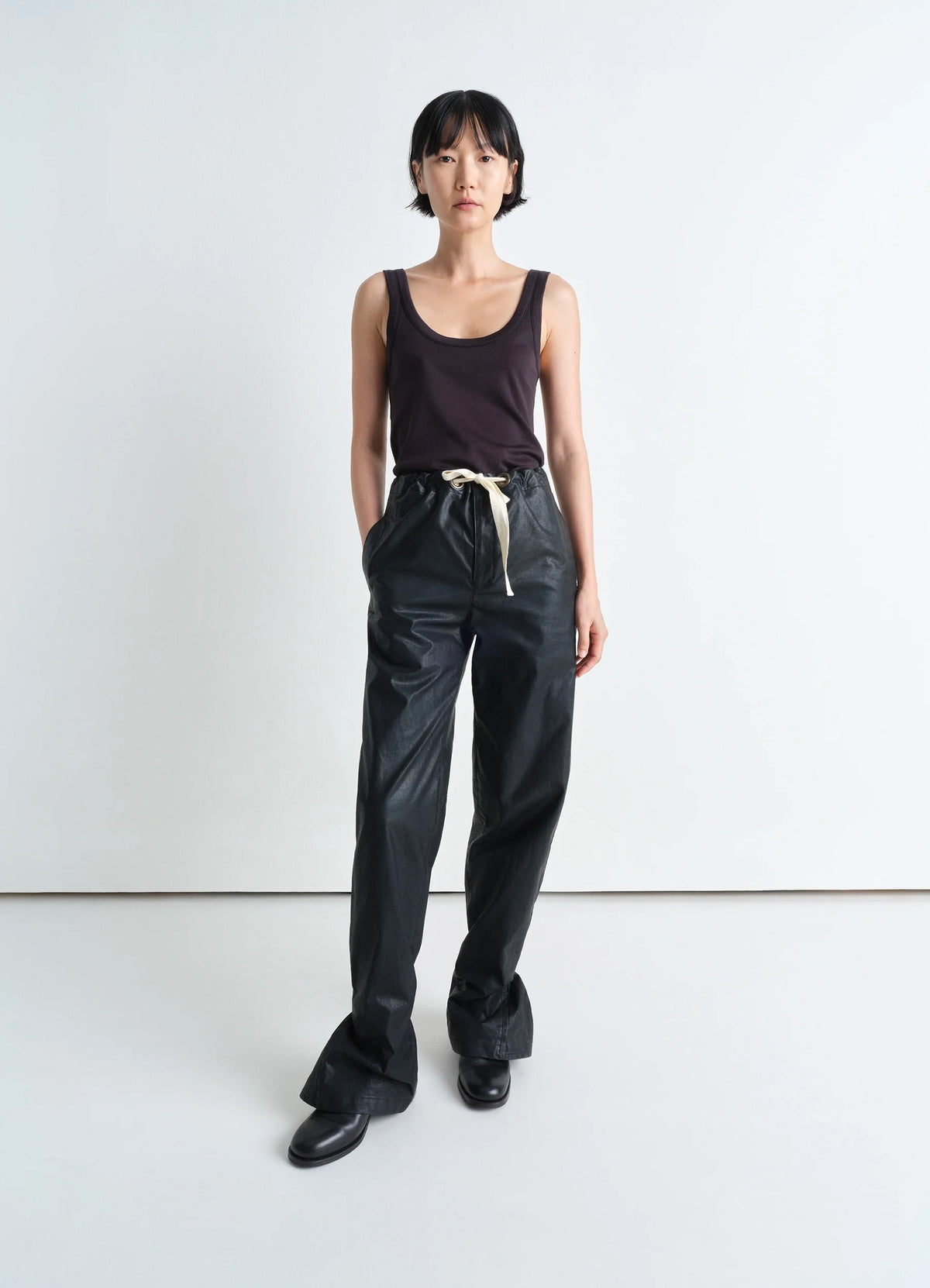 Lemaire Straight Rain Pants in Black Resinated Cotton, model shot, front view straight leg with gusset
