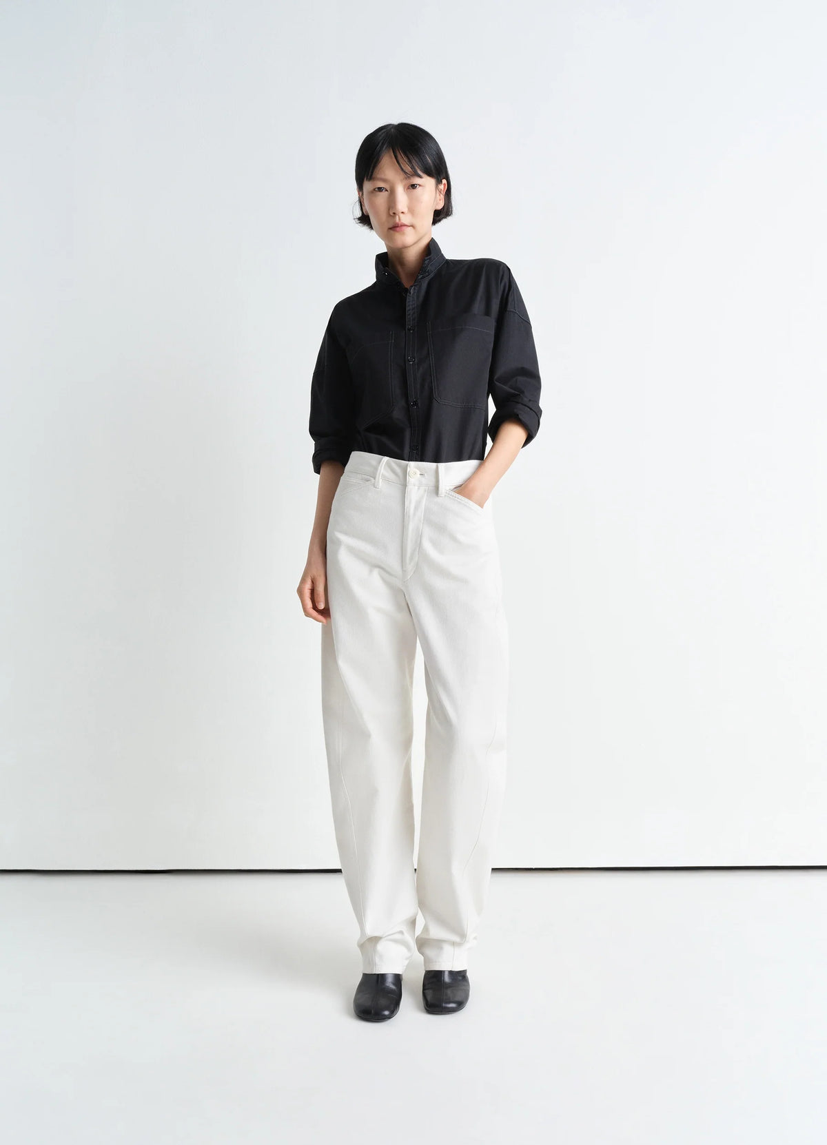 Lemaire Five Pocket Twisted Pants in Cotton Drill White, model shot, front view straight leg, twisted seam