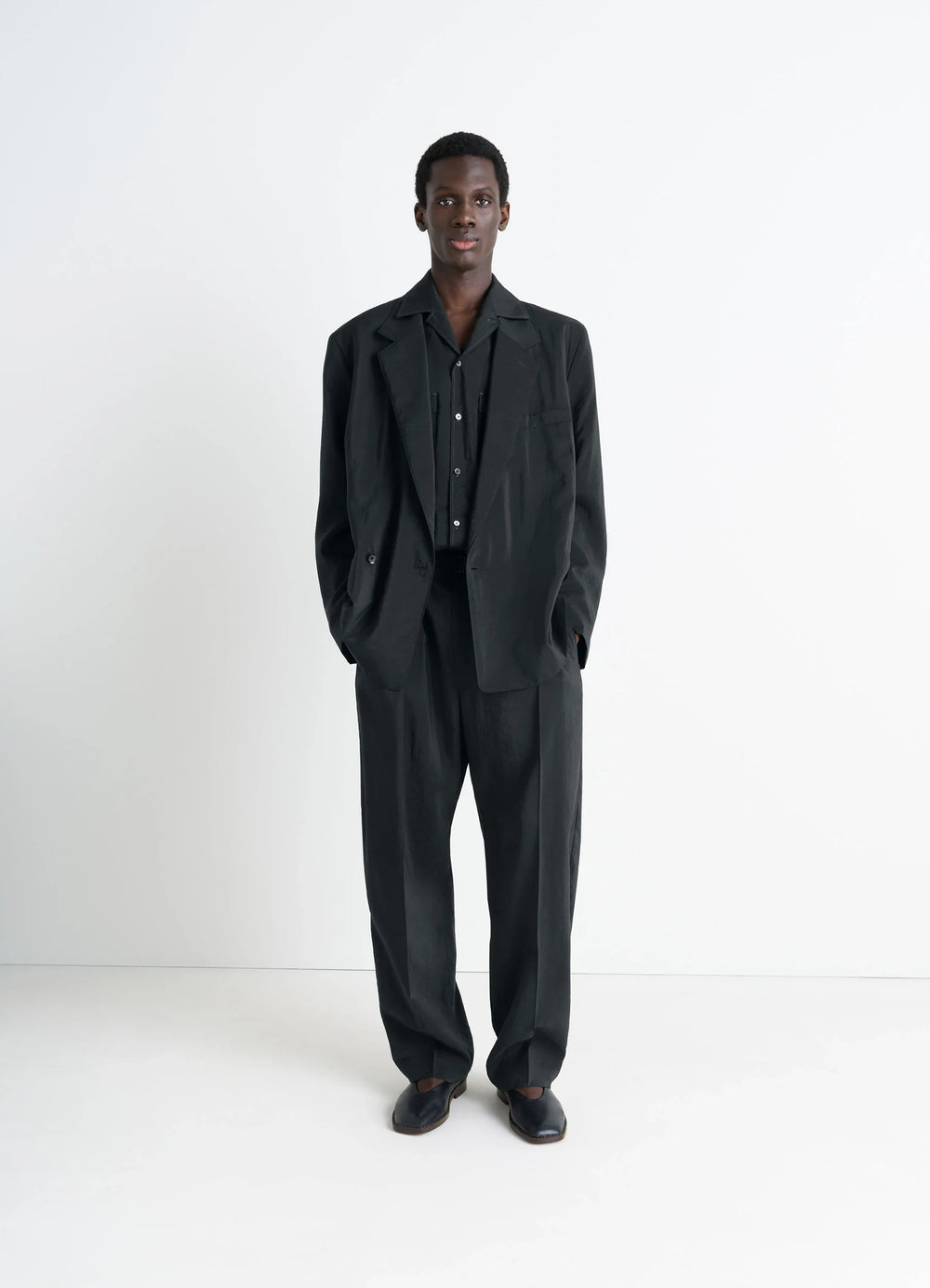 Lemaire Belted Relaxed Pants in Black Dry Silk Blend, model shot, full body view elasticated waistband