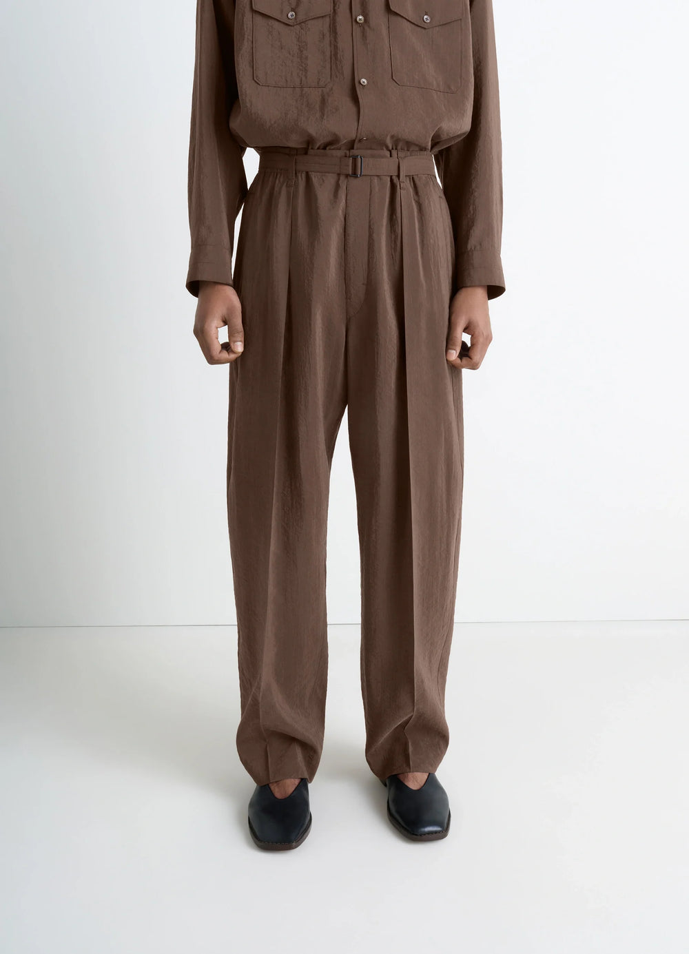 Lemaire Belted Relaxed Pants in Brown Dry Silk Blend, model shot, back view tapered leg with pleats